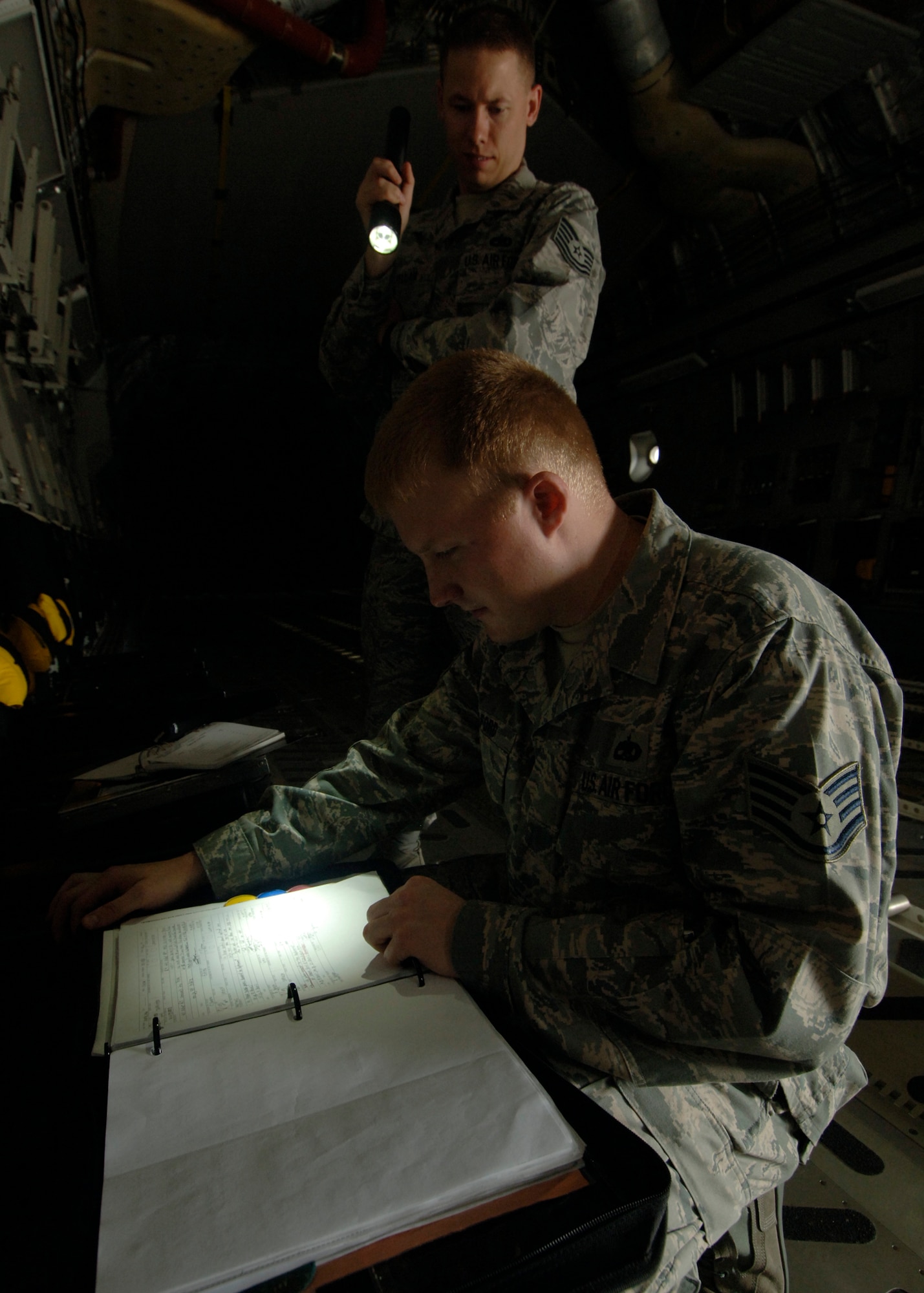 Tech. Sgt. Robert Pellam and Staff Sgt. Andrew Alford review aircraft forms to ensure all discrepancies are documented so maintenance can correct the deviations here April 1. Quality assurance checks are performed to ensure maintenance quality, personal safety, reliability and flight safety are adhered to for the 437th Maintenance Group. Sergeant Pellam is a crew chief quality assurance inspector and Sergeant Alford is a fabrication quality inspector. Both are with the 437th Maintenance Group. (U.S. Air Force photo/Senior Airman Timothy Taylor)