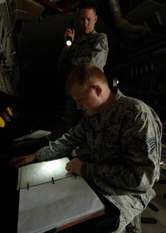 Tech. Sgt. Robert Pellam and Staff Sgt. Andrew Alford review aircraft forms to ensure all discrepancies are documented so maintenance can correct the deviations here April 1. Quality assurance checks are performed to ensure maintenance quality, personal safety, reliability and flight safety are adhered to for the 437th Maintenance Group. Sergeant Pellam is a crew chief quality assurance inspector and Sergeant Alford is a fabrication quality inspector. Both are with the 437th Maintenance Group. (U.S. Air Force photo/Senior Airman Timothy Taylor)