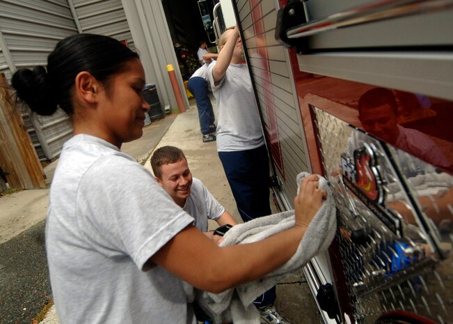 Staff Sgt. Sheralee Freche volunteers with first-term Airmen at the Ashley River Fire Department to detail fire engines in North Charleston March 31. Upon arriving at FTAC, first-term Airmen are highly encouraged to volunteer their time around the community. The First Term Airman Center runs a program designed to show new Airmen around the Charleston area and help them have a clean transition into their first base. Sergeant Fresche is the team leader for FTAC and is a member of 437th Logistics Readiness Squadron. (U.S. Air Force photo/Senior Airman Timothy Taylor)