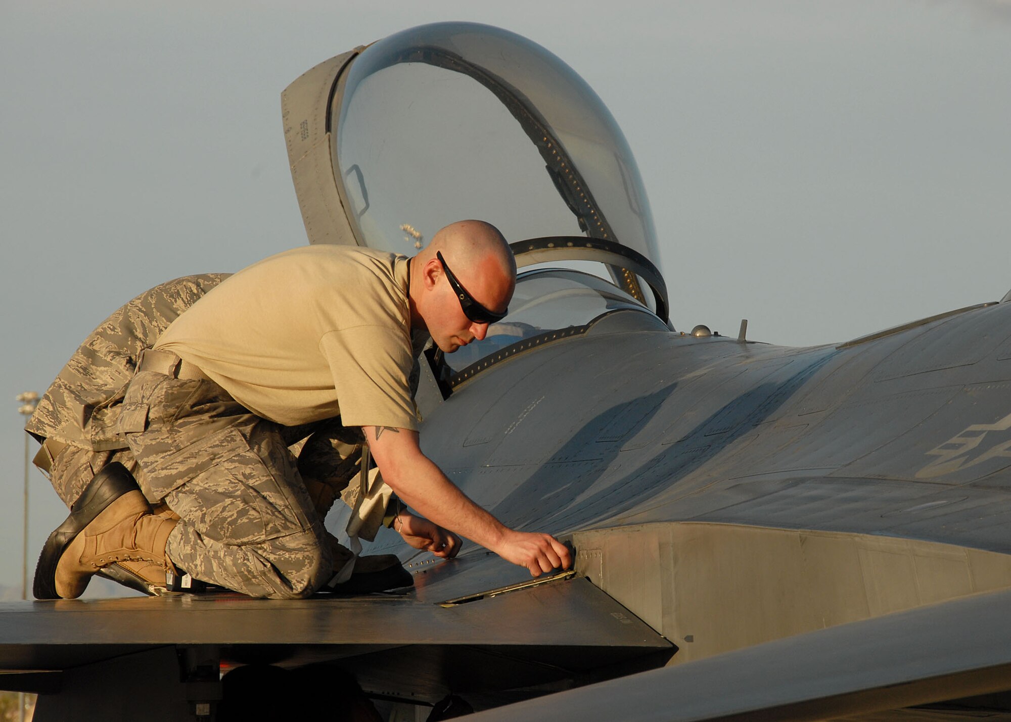 US Air Force Airman First Class William McConnell is working on the tail of a 174th FW's F-16 at Nellis AFB on March 25th 2009.  A1C McConnell is part of the last scheduled deployment supporting the Weapons Instuctors course. (US Air Force photo by SSgt Ricky Best/RELEASED)