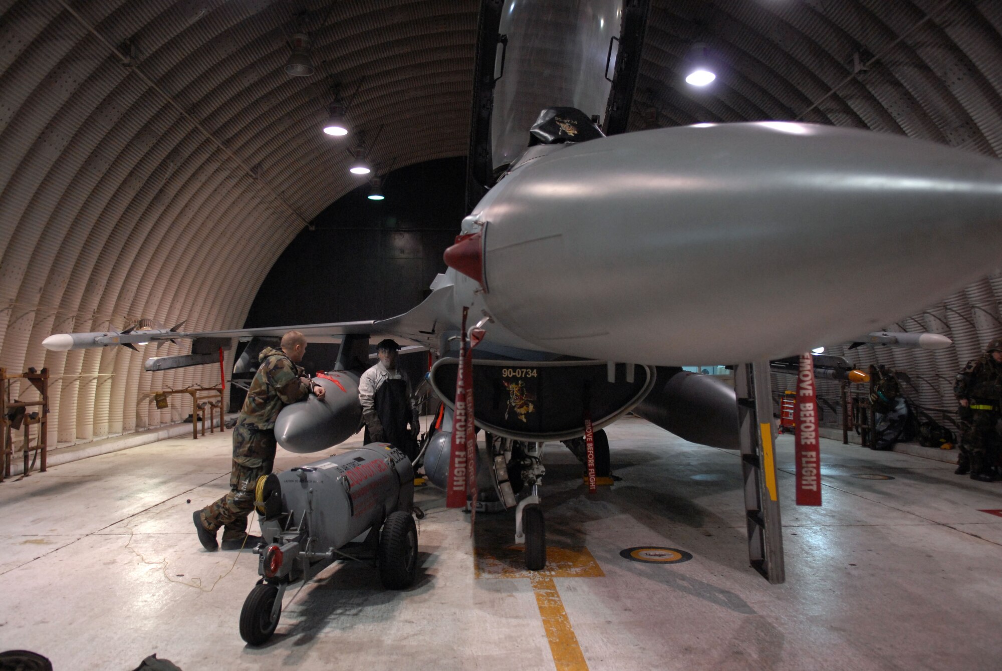 Senior Airman Amed Poveda 80th Aircraft Maintenance unit and Senior Airman Alex Yaste 8th Maintenance Squadron, crew chief's, conduct a liquid oxygen servicing on a  F-16 ensuring the pilot's oxygen system is properly maintained for the next use, at Kunsan Air Base, Republic of Korea, during the beverly bulldog 09-02 peninsula-wide operational readiness exercise April 2, 2009. Airman of the wolf pack practice their war time capabilities in the PENORE to properly prepare for an upcoming Operational Readiness Inspection.(US Air Force Photo By: Senior Airman Angela Ruiz)(Released By:8th Fighter Wing, Public Affairs Office, Staff Sgt. Trevor Tiernan) 