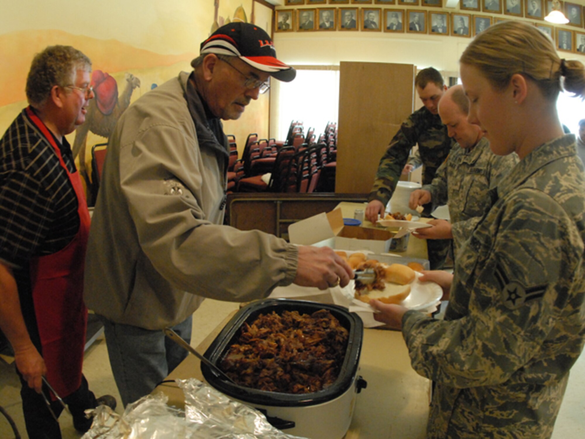 A1C Kristen E. Thomsen receives food from a Fargo Shriner while working flood operations on March 31, 2009 in Fargo, N.D.