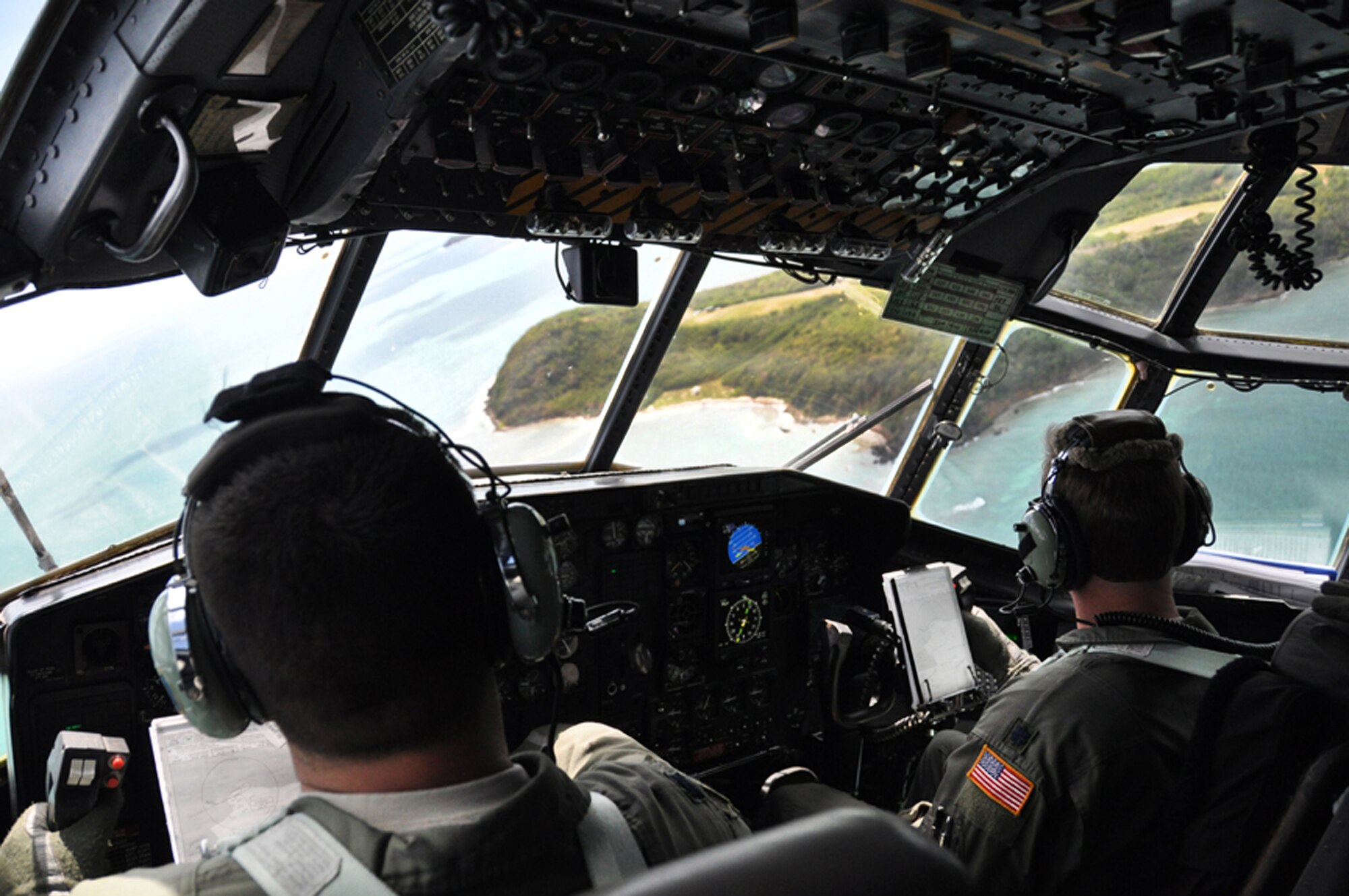 Two North Carolina Air National Guard pilots fly a C-130 Hercules over the island of Puerto Rico as part of the hub-and-spoke mission executed by Airmen from the 621st Contingency Response Wing at McGuire Air Force Base, N.J., during the Vigilant Guard exercise held March 23 to 29. The large-scale disaster relief exercise incorporated Puerto Rican and federal agencies and more than 80 CRW Airmen spread throughout five locations in Puerto Rico.  (U.S. Air Force photo/1st Lt. Dustin Doyle) 