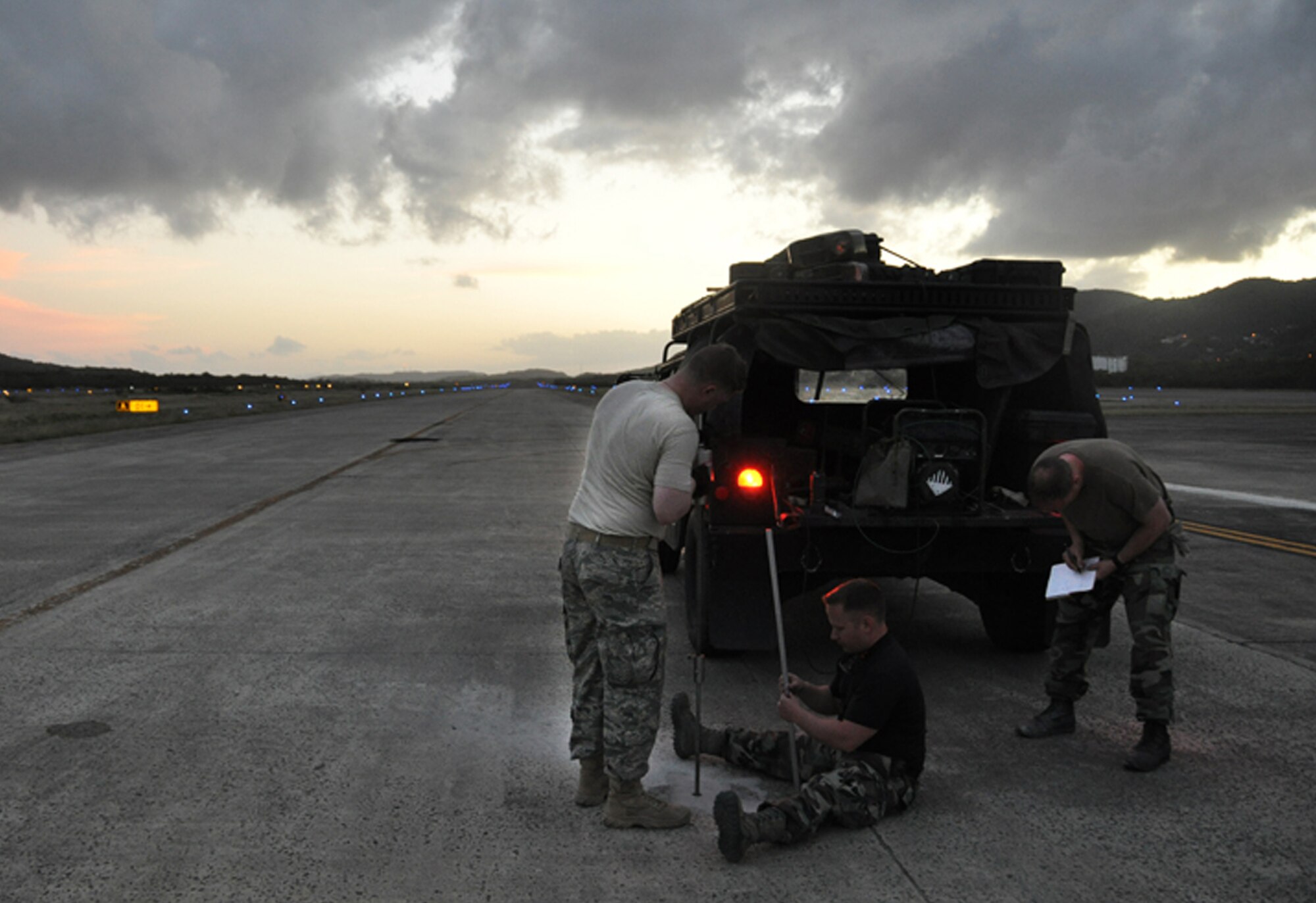 Capt. Brian Loveless (from left), Staff Sgt. Joseph Reed and Capt. Luke Stumme, members of the 817th Contingency Response Group's "Alpha Mike" airfield assessment team, conduct density tests on soil beneath a runway during the Vigilant Guard exercise in Puerto Rico March 23 to 29. The completed assessment will be used "real-world" to certify the runway for use by various mobility aircraft.  The 817th CRG is part of the 621st Contingency Response Wing at McGuire Air Force Base, N.J.  (U.S. Air Force photo/1st Lt. Dustin Doyle) 