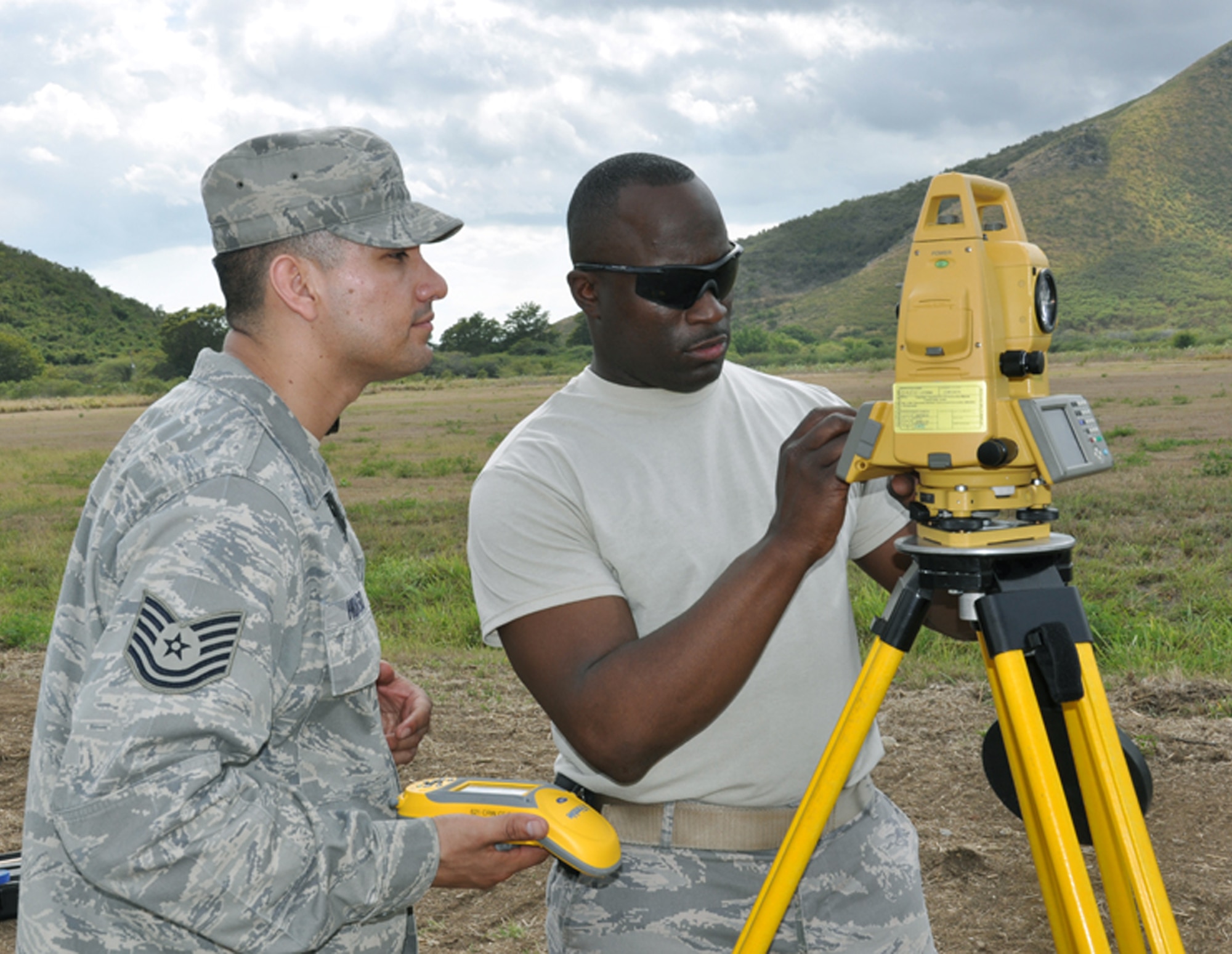 Tech. Sgt. Rob Hidalgo (left) and Master Sgt. Lamar Heard, members of the 817th Contingency Response Group's "Alpha Mike" airfield assessment team, use a laser range finder to take the measurements of a proposed landing strip during the Vigilant Guard exercise held in Puerto Rico March 23 to 29.  The 817th CRG is part of the 621st Contingency Response Wing at McGuire Air Force Base, N.J.  (U.S. Air Force photo/1st Lt. Dustin Doyle)