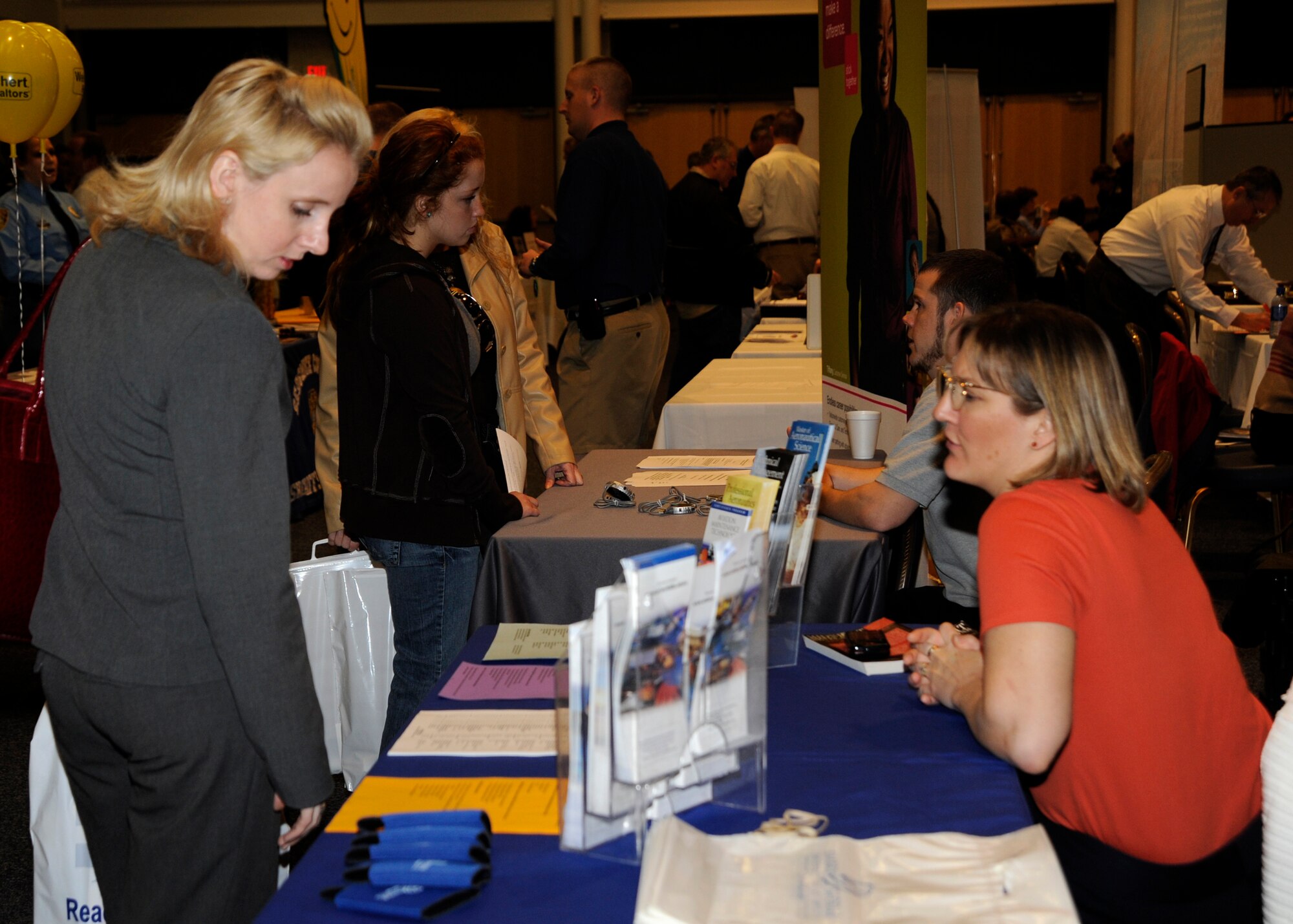 MCCONNELL AIR FORCE BASE, Kan. -- Civilian and military members browse through different tables for job opportunities during a job fair at the Robert J. Dole Community Center, March 25. The Airman and Family Readiness Center invites different companies and hosts McConnell’s job fair annually. (Photo by Airman Justin Shelton) 