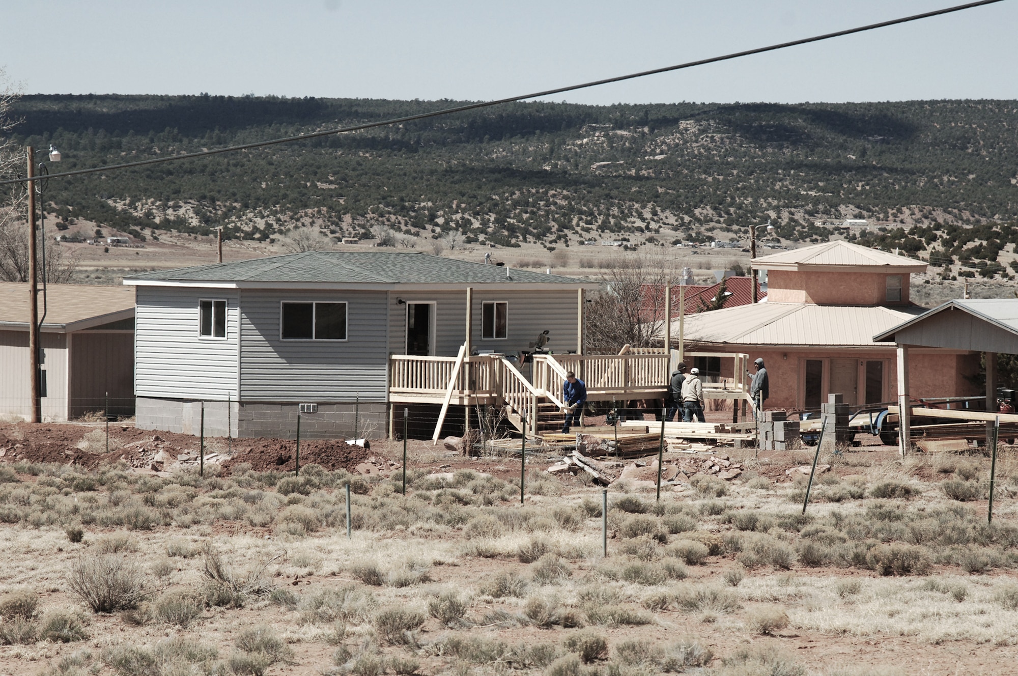 U.S. Air Force Academy cadets and faculty work with site managers to help build low-cost housing on the Navajo Reservation in Arizona. (U.S. Air Force photo/John Van Winkle) 
