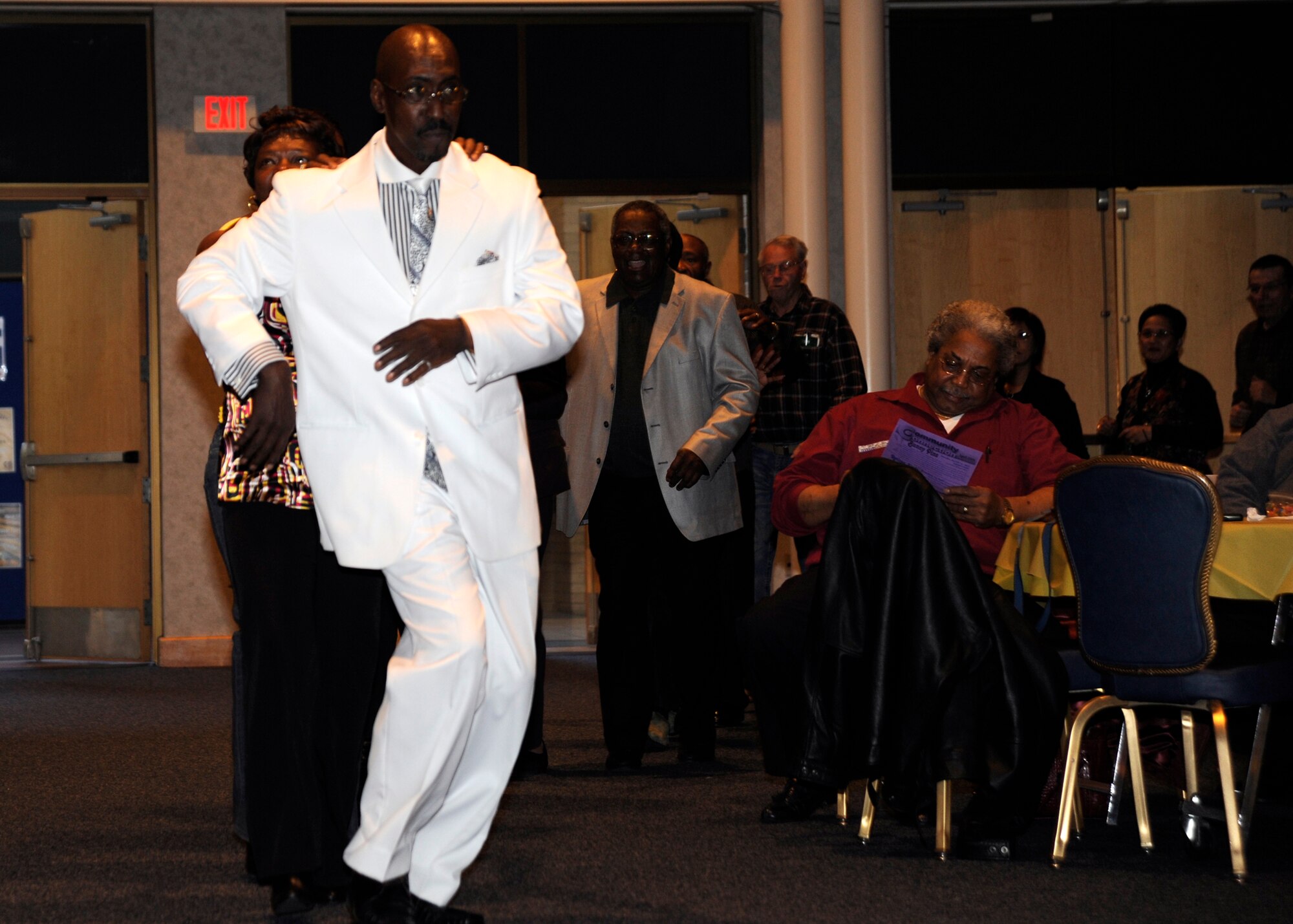 MCCONNELL AIR FORCE BASE, Kan. -- Larry McKnight, one of The Legendary Drifters, parades those in attendance through the Robert J. Dole Community Center ballroom for the final song during The Legendary Drifters concert, March 29. (Photo by Airman Justin Shelton) 