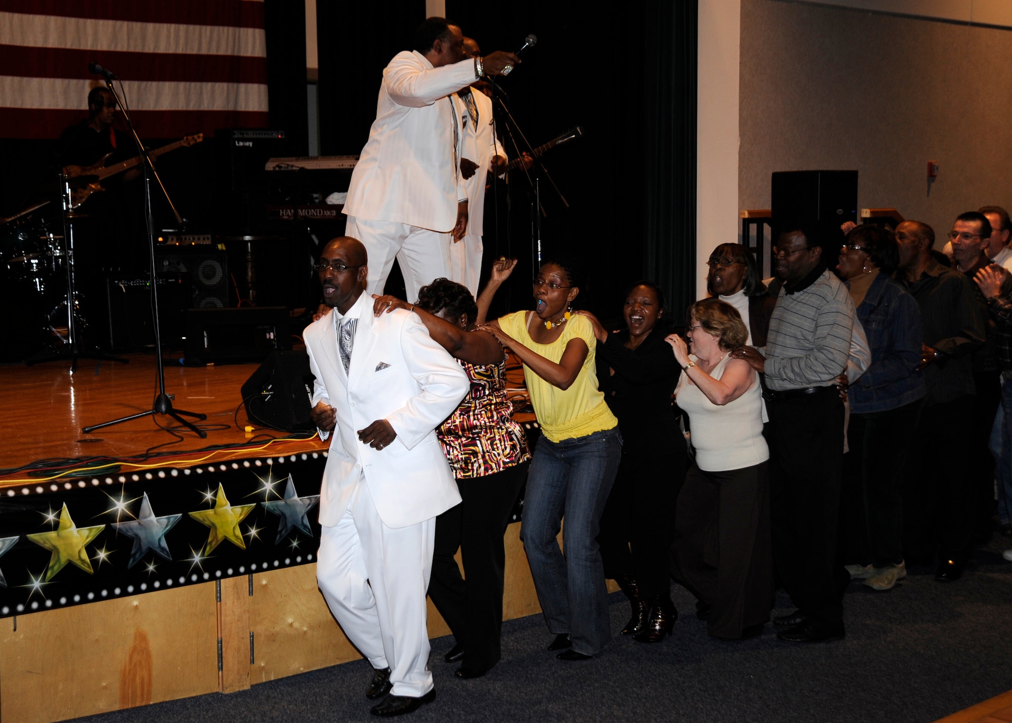 MCCONNELL AIR FORCE BASE, Kan. -- Larry McKnight, Legendary Drifter, leads the audience in a dance around the Robert J. Dole Community Center ballroom as his fellow band members perform, March 29. Mr. McKnight was recruited by lead singer Logan Lee and has been with The Legendary Drifters for five years. (Photo by Airman Justin Shelton) 