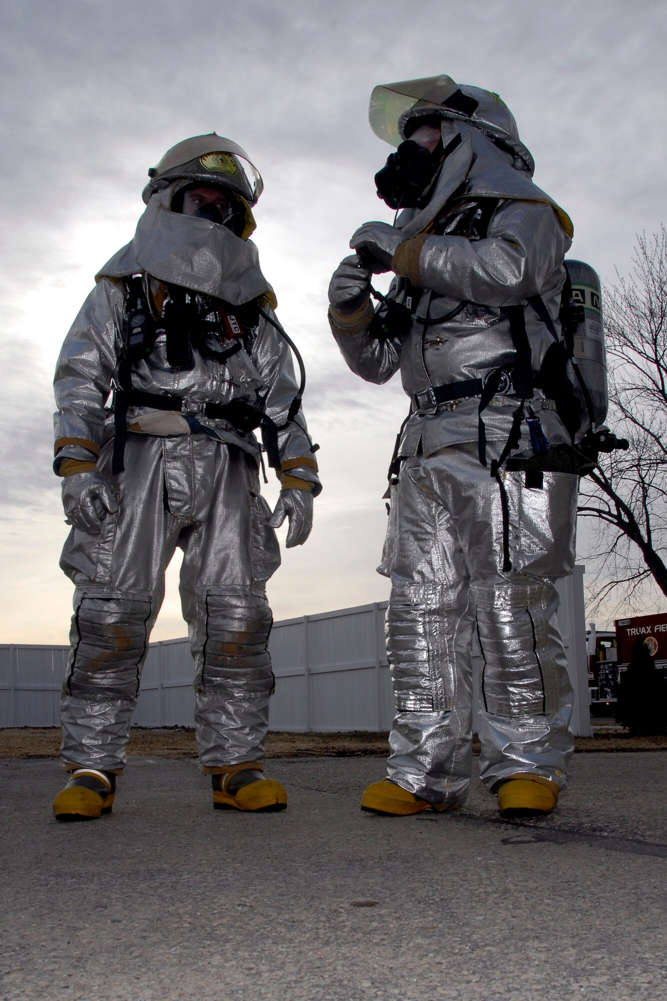 Two fire fighters from the 115th Fighter Wing Fire Department strategize about emergency response tactics outside of Bldg. 500 where a “suspicious” package was found March 18 as part of an exercise here. The joint exercise included many different units on Truax Field as well as the U.S. Postal Service, Federal Bureau of Investigation and the 54th Civil Support Team. (U.S. Air Force Photo by Master Sgt. Dan Richardson)
