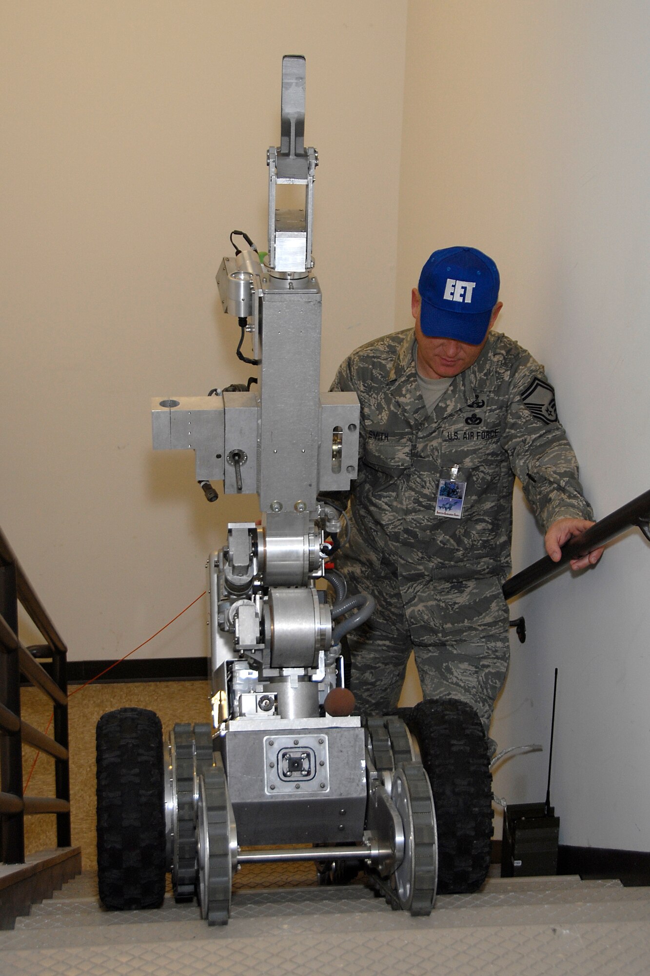 Senior Master Sgt. Edward Smith, 115th Explosive Ordnance Disposal Flight and Exercise Evaluation Team member, walks behind the F-6A Andros hazardous duty robot that was used to give critical intelligence to responding forces during a suspicious package exercise held at here March 18. The joint exercise included many different units on Truax Field as well as the U.S. Postal Service, Federal Bureau of Investigation and the 54th Civil Support Team. (U.S. Air Force Photo by Master Sgt. Dan Richardson)

