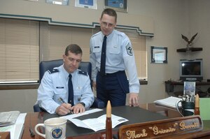 LANGLEY AIR FORCE BASE, Va. – Brig. Gen. Mark A. Barrett, 1st Fighter Wing commander, and Chief Master Sgt. Kevin Slater, 1st FW command chief, contribute to the Air Force Assistance Fund here March 30. The AFAF campaign has benefited active duty, Reserve, Guard, retired Air Force personnel, surviving spouses and families with contributions for 36 years. This year's campaign runs now till April 19, with a goal of raising $5.8 million. (U.S. Air Force Photo/Senior Airman Cecil C. McCloud)
