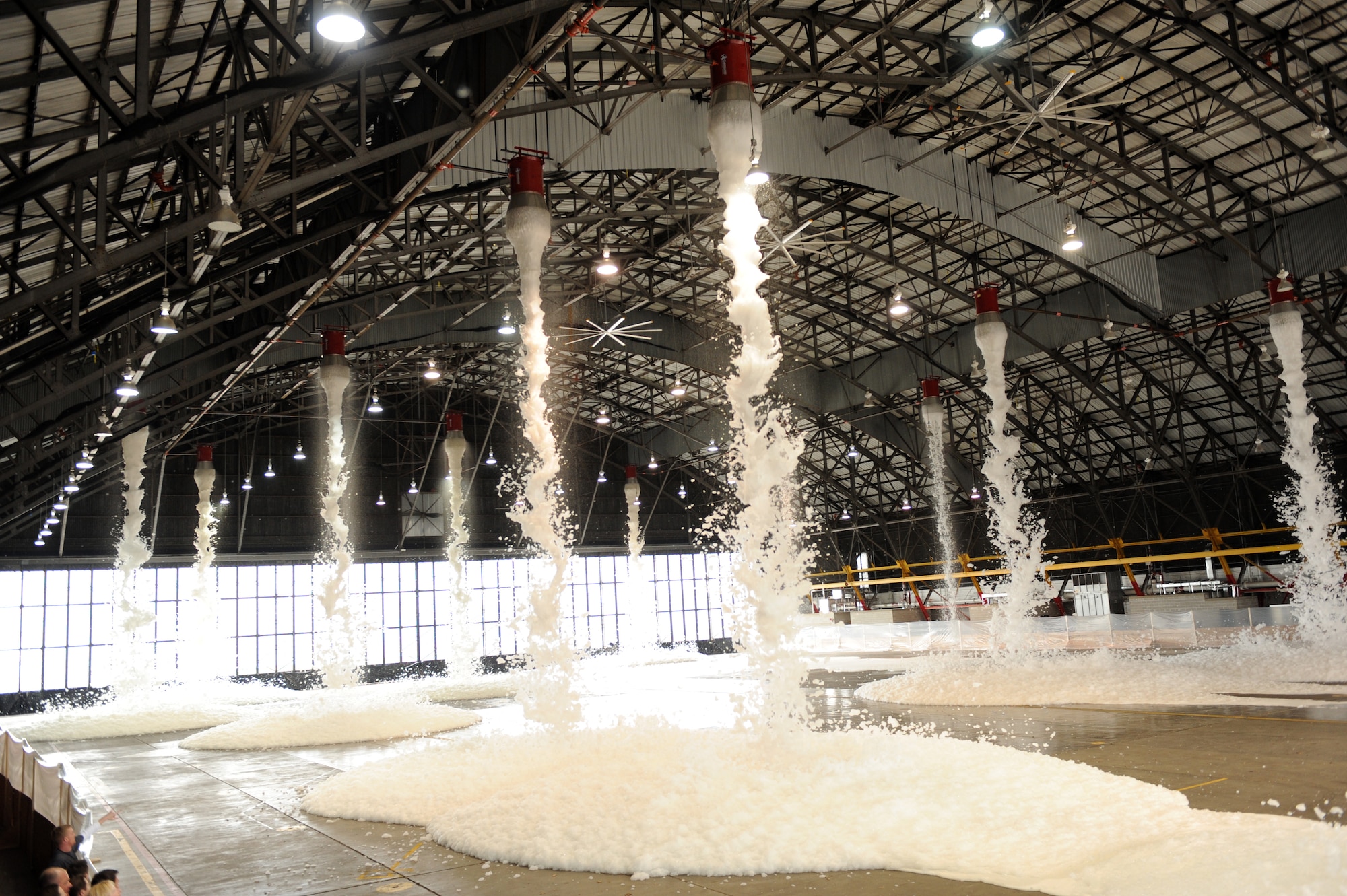 SCOTT AIR FORCE BASE. Ill. -- Foam rains down from a new fire fire suppression system in Hangar 1 March 24 during a system test. (U.S. Air Force photo/Staff Sgt. Paul Villanueva II)