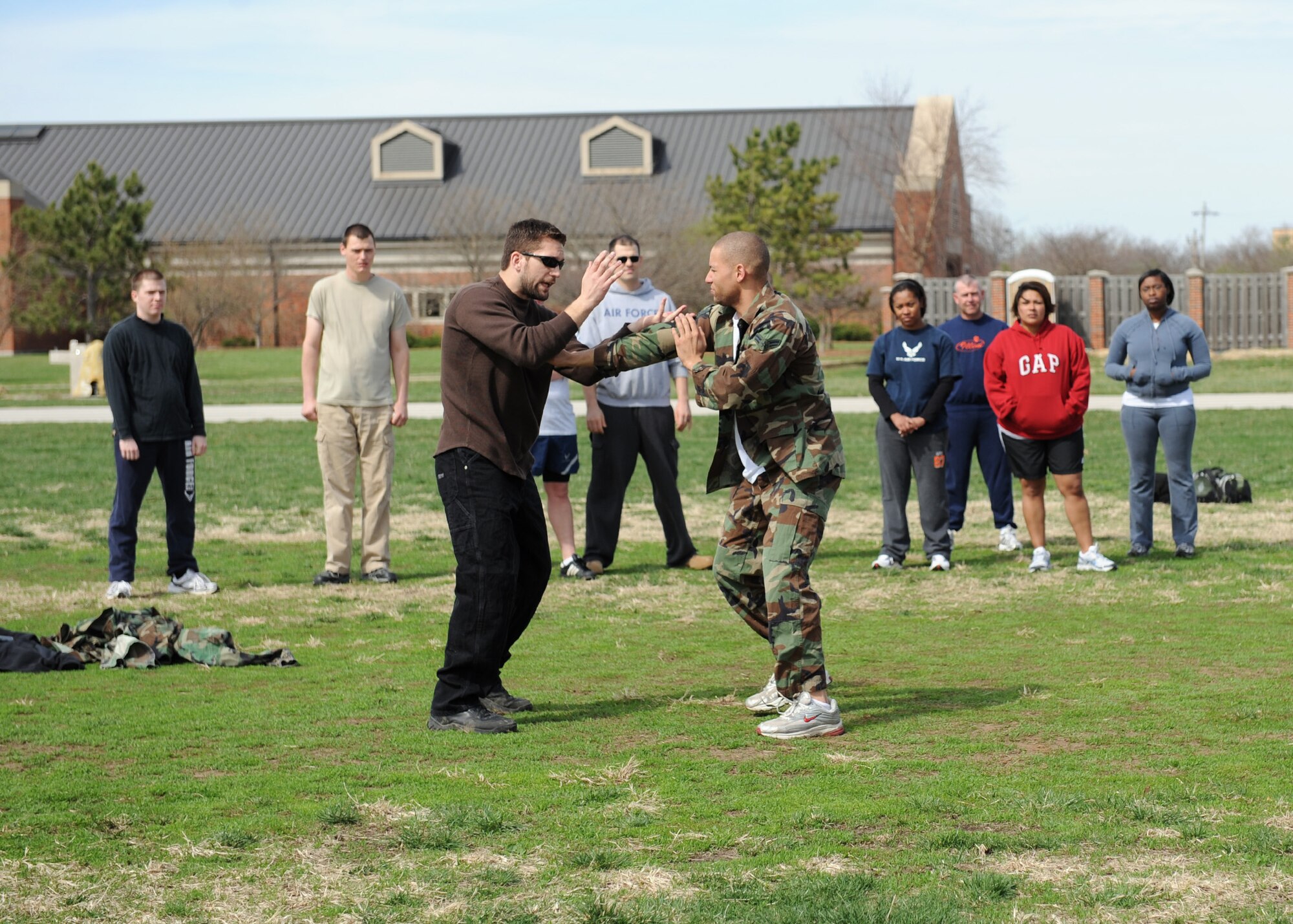 SCOTT AIR FORCE BASE. Ill. -- Instructor Gary Meek, left, demonstrates a self-defensive technique on Dominic Brisbin, also an instructor, to the NCO Enhancement Program class. This instruction was different from the typical classroom lectures and it taught NCOs valuable skills. (U.S. Air Force photo/Staff Sgt. Paul Villanueva II)  