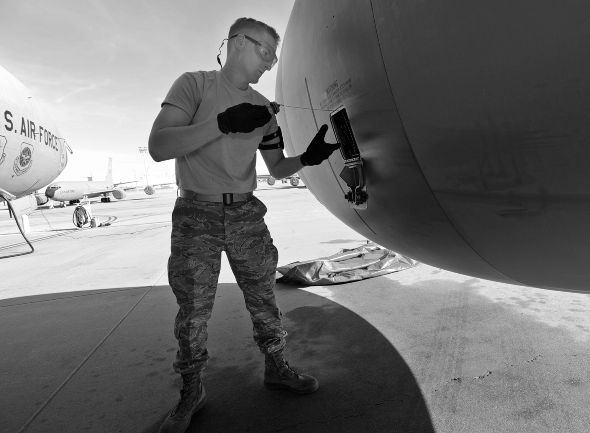 Staff Sgt. Alan Pedersen checks the oil inside a KC-135 Stratotanker parked on the flightline at McConnell Air Force Base, Kan. Sergeant Pedersen is a crew chief assigned to the 931st Aircraft Maintenance Squadron, an Air Force Reserve unit at McConnell. (U.S. Air Force photo/Tech. Sgt. Jason Schaap)