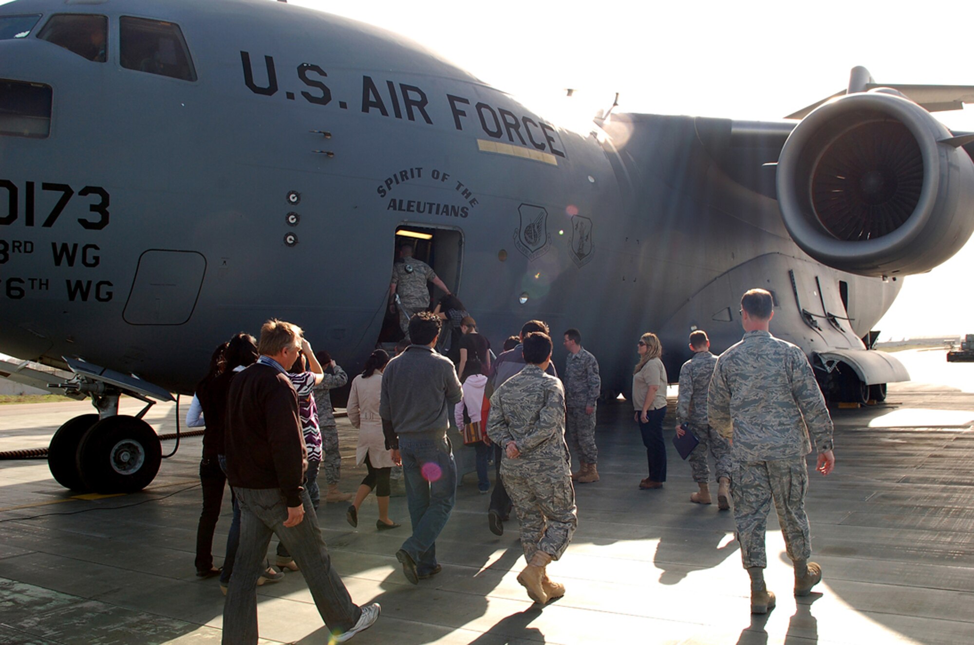 A group of students and faculty from the American University of Central Asia in Bishkek climb aboard a C-17 Globemaster III during a March 26 tour of Manas Air Base, Kyrgyzstan. They visit provided the students a look at the missions carried out daily in support of operations in Afghanistan. (U.S. Air Force photo/Tech. Sgt. Phyllis Hanson) 
