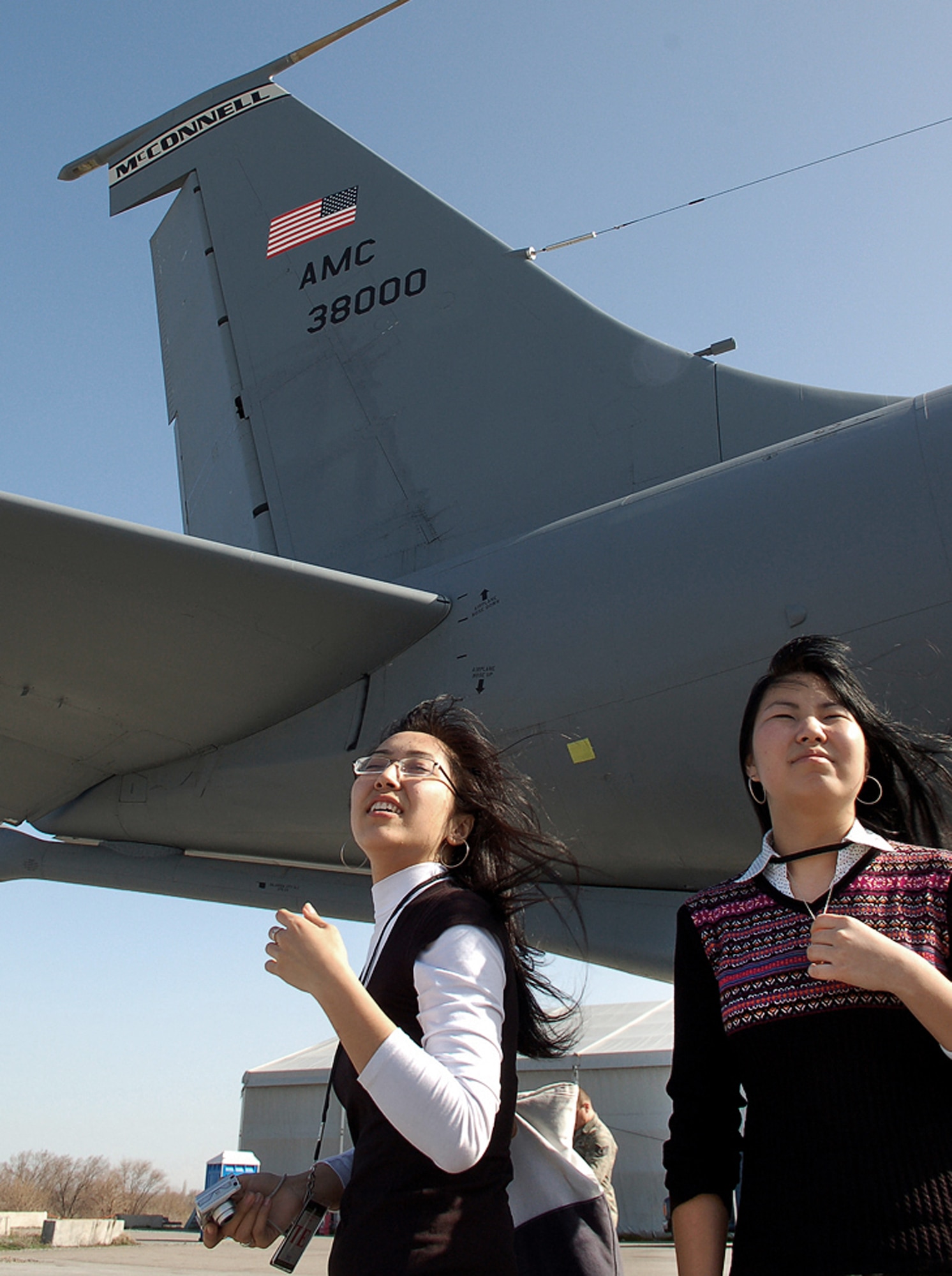 Jangyl Ismailova and Asel Botpayeva explore the flightline and the fleet of KC-135 Stratotankers March 26 at Manas Air Base, Kyrgyzstan. Ms. Ismailova and Ms. Botpayeva were two of 13 students from the American University of Central Asia in Bishkek who visited Manas AB with other students and faculty for an orientation tour and dinner hosted by the 376th Air Expeditionary Wing Public Affairs office. (U.S. Air Force/Tech. Sgt. Phyllis Hanson) 
