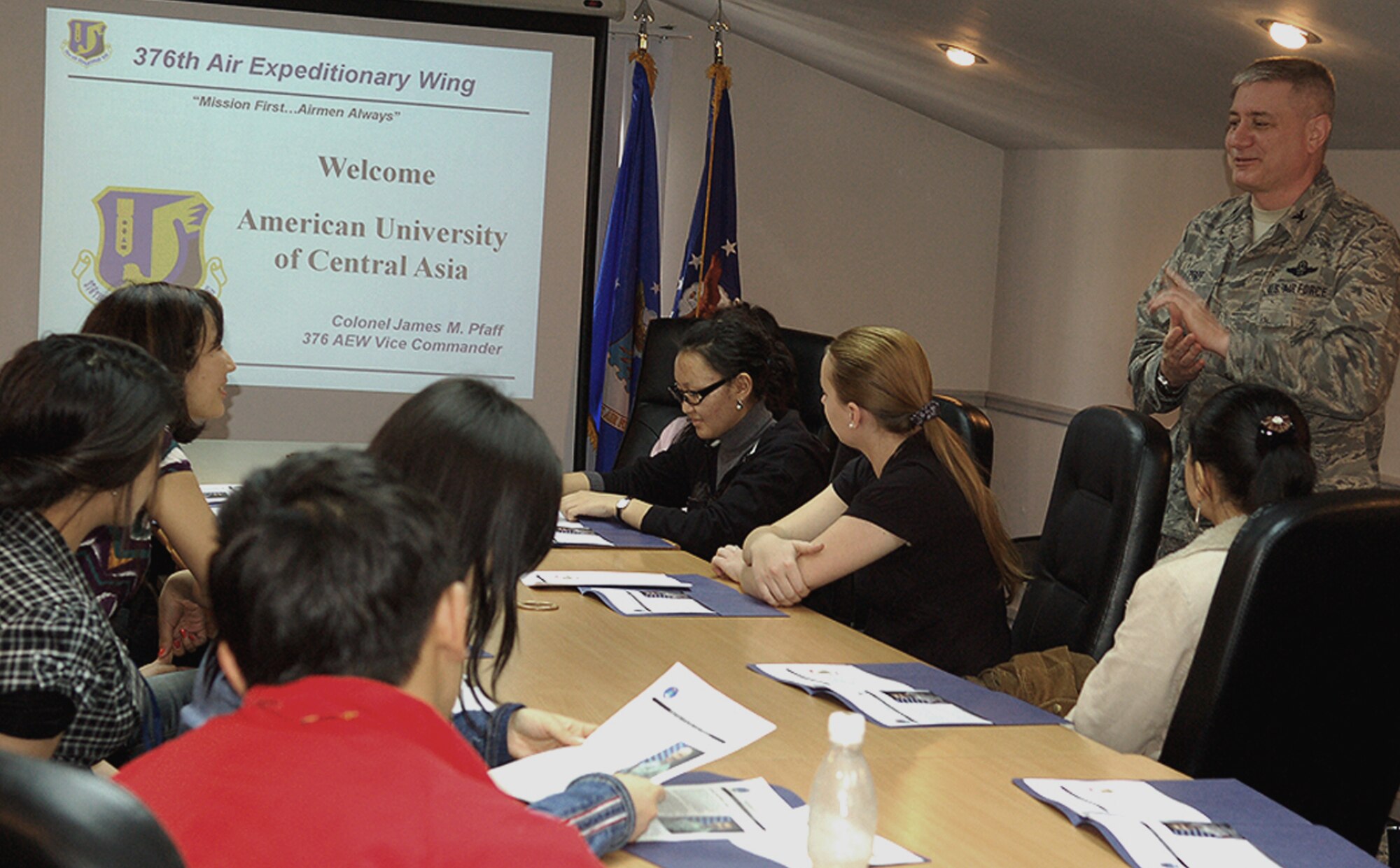 Colonel James Pfaff gives a mission briefing March 26 to 13 students and faculty members from the American University of Central Asia who visited Manas Air Base, Kyrgyzstan. The visit provided the students a look at the missions carried out daily in support of operations in Afghanistan, while building friendships with coalition personnel deployed here. Colonel Pfaff is the the 376th Air Expeditionary Wing vice commander. (U.S. Air Force/Tech. Sgt. Phyllis Hanson) 
