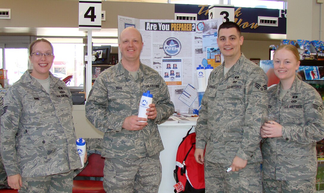 From left, Staff Sgt. Danielle Ring, NCO in charge of emergency management, Staff Sgt. Thomas Bohl, NCO in charge of logistics at emergency management, Senior Airman Travis DePrinzio, in charge of training, and Senior Airman Jennifer DePrinzio, in charge of plans and operations, of the 71st Logistics Readiness Squadron's Emergency Management Team, held a demonstration on how to build and maintain an emergency supply kit in the Vance commissary March 31. (U.S. Air Force photo by 2nd Lt. Lynn Aird)