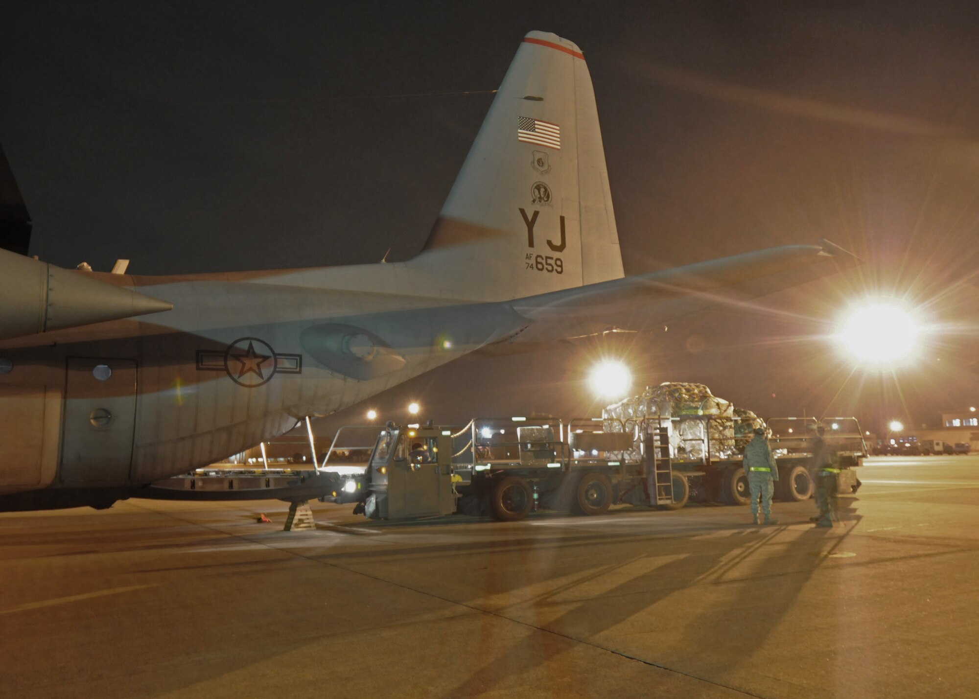 Members of the 36th Airlift Squadron and 730th Air Mobility Squadron guide a pallet into the cargo compartment of a C-130 Hercules during Phase I of Exercise Beverly Morning 09-03 March 31 at Yokota Air Base, Japan. Base personnel will be conducting the exersice March 30 through April 3 to maintain operational readiness. (U.S. Air Force photo/Senior Airman Veronica Pierce) 
