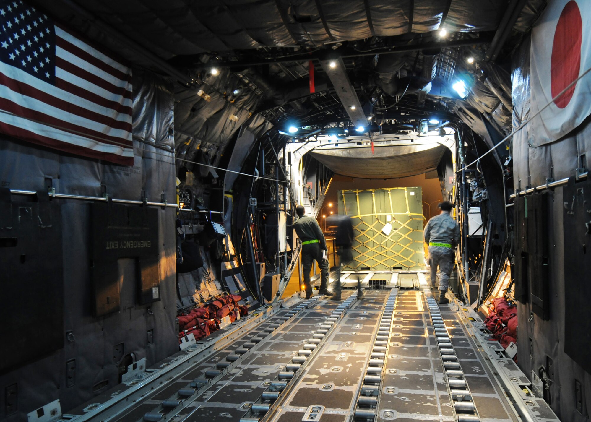 Members of the 36th Airlift Squadron and 730th Air Mobility Squadron guide a pallet into the cargo compartment of a C-130 Hercules during Phase I of Exercise Beverly Morning 09-03 March 31 at Yokota Air Base, Japan. Base personnel will be conducting the exercise March 30 through April 3 to maintain operational readiness. (U.S. Air Force photo/Senior Airman Veronica Pierce) 
