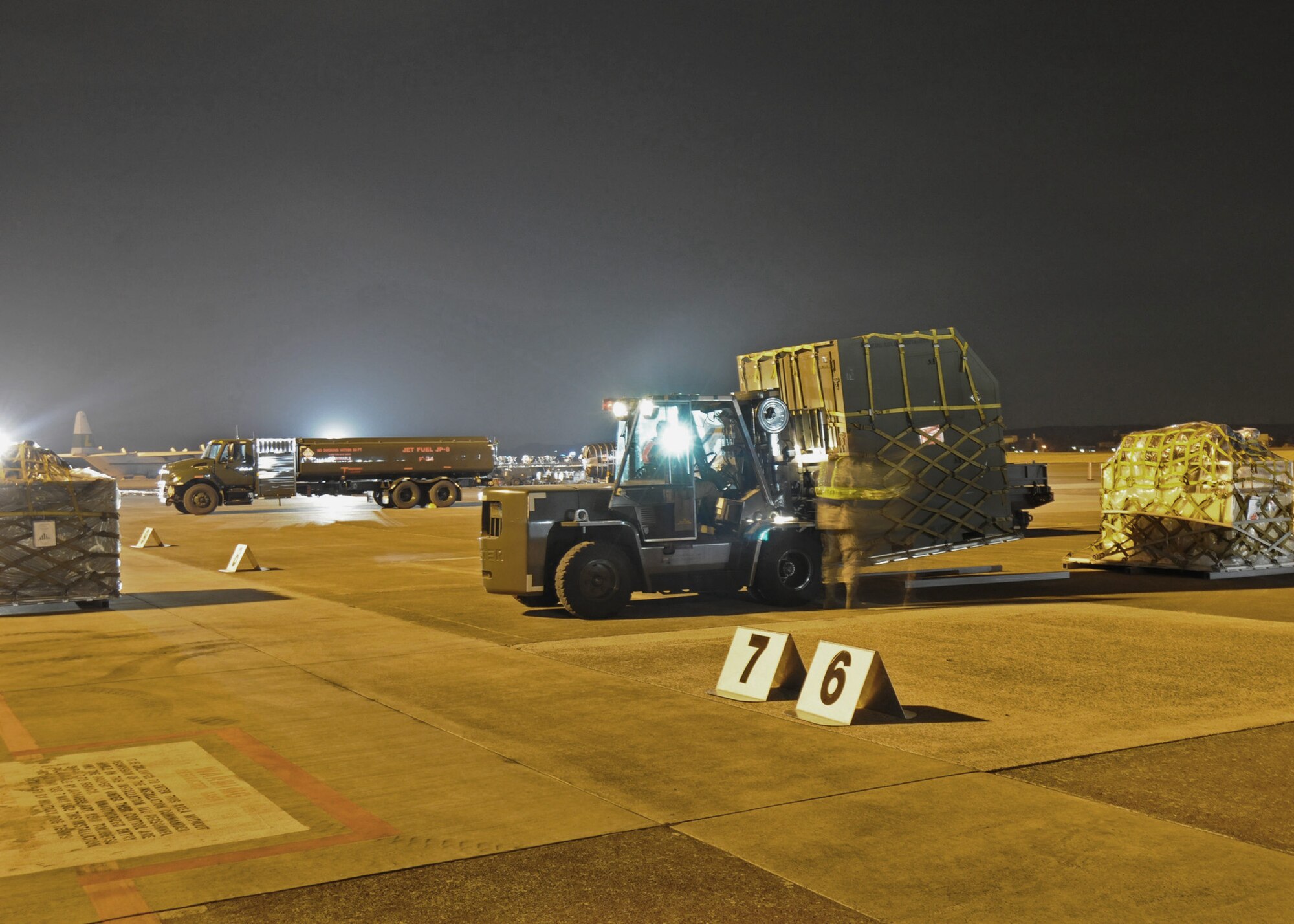 Members of the 374th Aircraft Maintenance Squadron and 730th Air Mobility Squadron prepare pallets for uploading to a C-130 Hercules during Phase I of Exercise Beverly Morning 09-03 March 31 at Yokota Air Base, Japan. Base personnel will be conducting the exercise March 30 through April 3 to maintain operational readiness. (U.S. Air Force photo/Senior Airman Veronica Pierce) 
