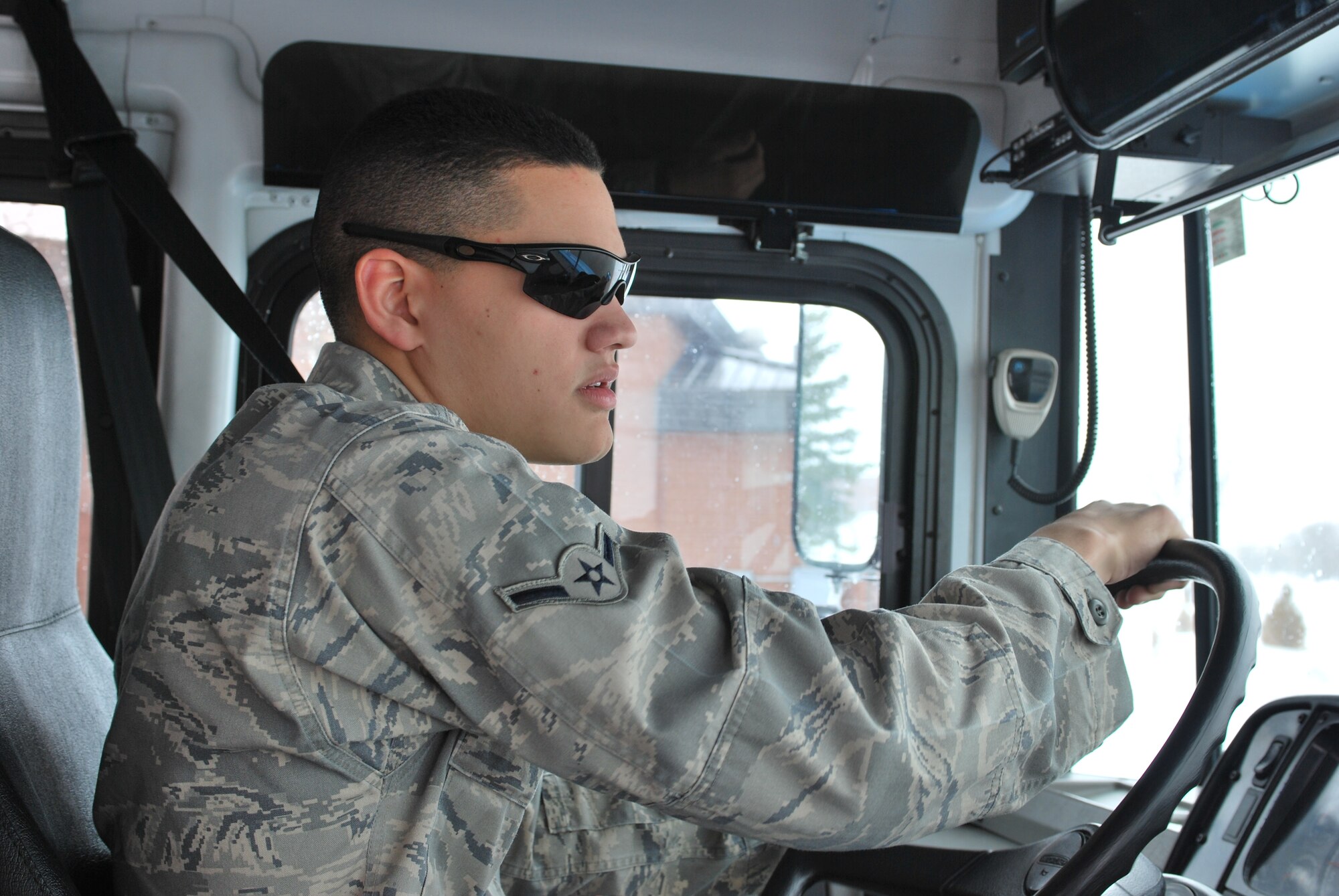 GRAND FORKS AIR FORCE BASE, N.D. -- Airman Peter Rivera, from the Minot AFB’s 5th Logistics Readiness Squadron, drives a base shuttle here March 31. The shuttles are currently running 24 hours to provide transportation for Airmen, Soldiers and other personnel here providing support for the base. Currently, 23 Airmen from Minot’s 5th Mission Support Group are helping out their fellow Airmen manage the high level of activity on the base due to the influx of servicemembers supporting the flood relief efforts along the Red River. (U.S. Air Force photo by Airman 1st Class Joshua Rosales)