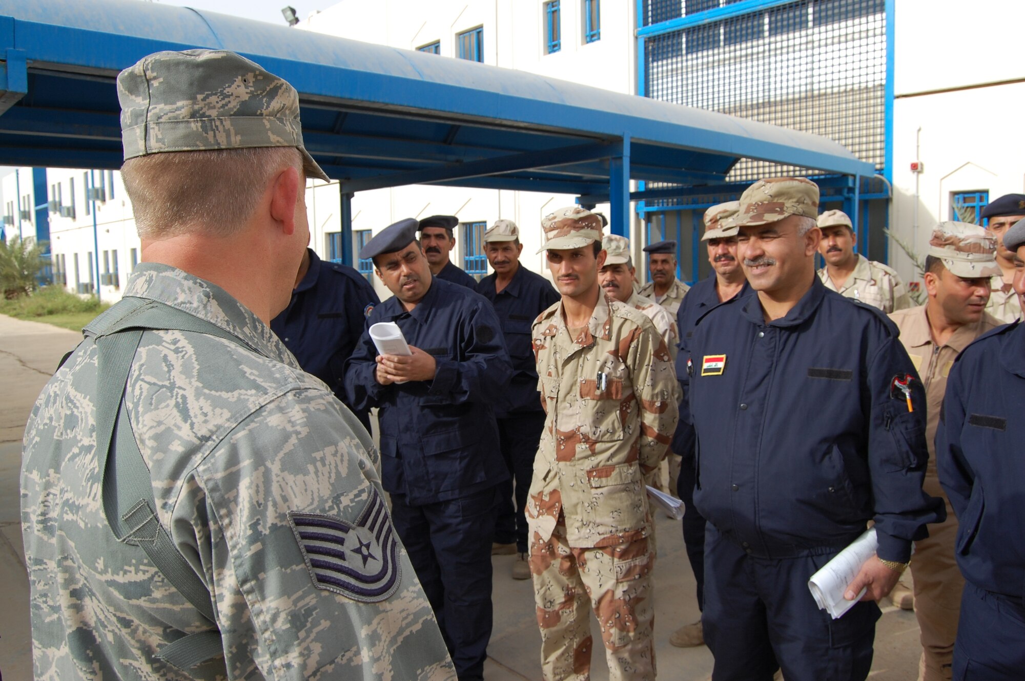 Tech. Sgt. Rick Dunaway, 821st Expeditionary Training Squadron Iraqi warrant officer professional development course instructor, briefs his students before they take their final exam March 28. Twenty-nine Iraqi warrant officers completed the seven-day course where they were taught lessons on discipline, leader influence, teamwork and development, ethics and values, Law of Armed Conflict and problem solving. Sergeant Dunaway is deployed from Maxwell-Gunter Air Force Base, Ala., and is a native of Russellville, Ark. (U.S. Air Force photo by Staff Sgt. Tim Beckham) 