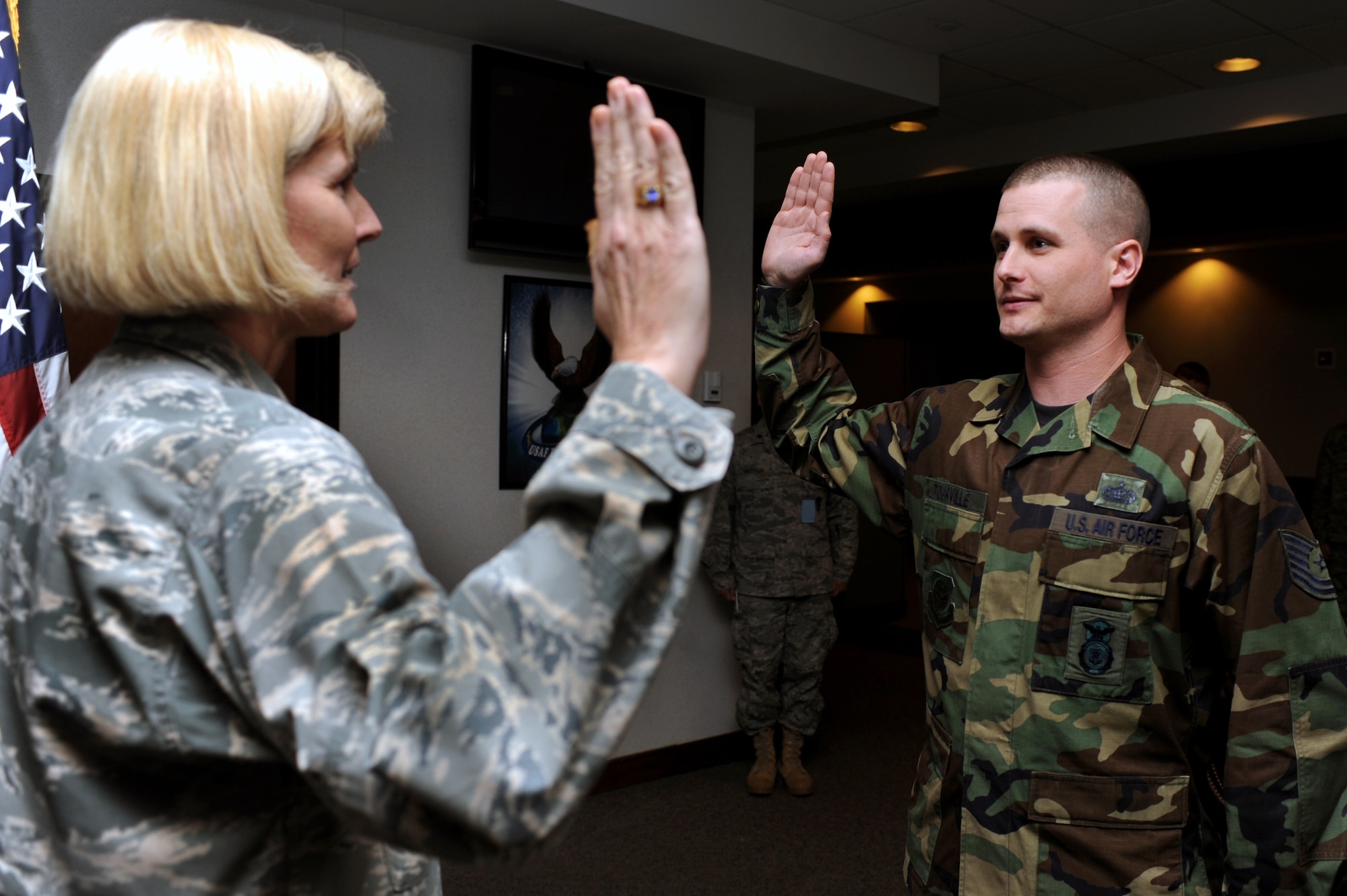 Brig. Gen. Mary Kay Hertog, Air Force Director of Security Forces at the Pentagon, reenlists Tech. Sgt. Jon Tourville of the 421st Combat Training Squadron during General Hertog's visit to the U.S. Expeditionary Center on Fort Dix, N.J., on March 26, 2009.  General Hertog also gave a presentation for the Expeditionary Center's Professional Development Speaker Series observing the center's 15th anniversary.  The speaking engagement was also teleconferenced to 15 locations Air Force-wide to include Japan, Germany, Nevada, Texas, Illinois, Hawaii and California. (U.S. Air Force Photo/Staff Sgt. Nathan G. Bevier) 