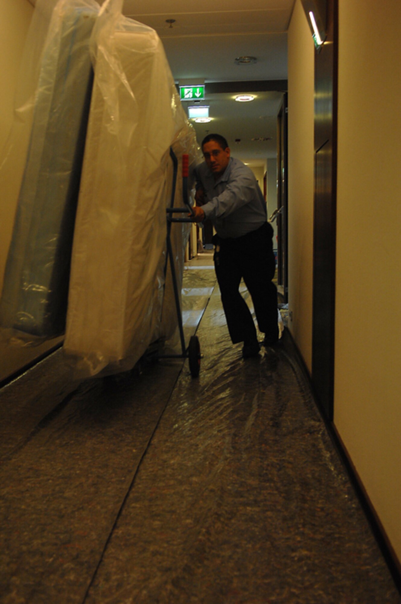 John Almodovar, Air Force Inns, moves mattresses for the new visitor quarters at the Kaiserslautern Military Community Center on Ramstein Air Base. The eight-story, 350-room visiting quarters facility will be one of the first areas to open as part of a $170 million project that will offer approximately 844,000 square feet of lodging, shopping and entertainment under one roof. (U.S. Air Force photo by Airman 1st Class Tony Ritter)
