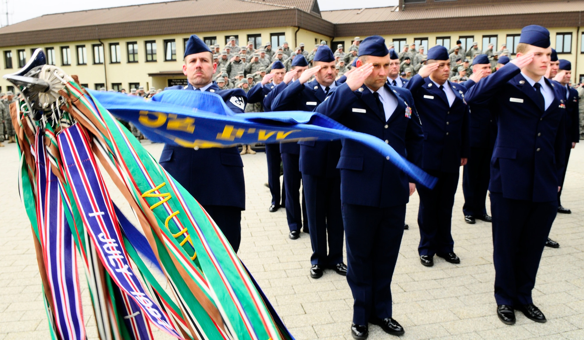 SPANGDAHLEM AIR BASE, Germany -- Members of the 52nd Fighter Wing salute during a memorial retreat ceremony for the first Chief Master Sergeant of the Air Force, Paul Airey, March 27, 2009.  He passed away March 11, 2009. (U.S. Air Force photo by Airman 1st Class Nicholas Wilson)