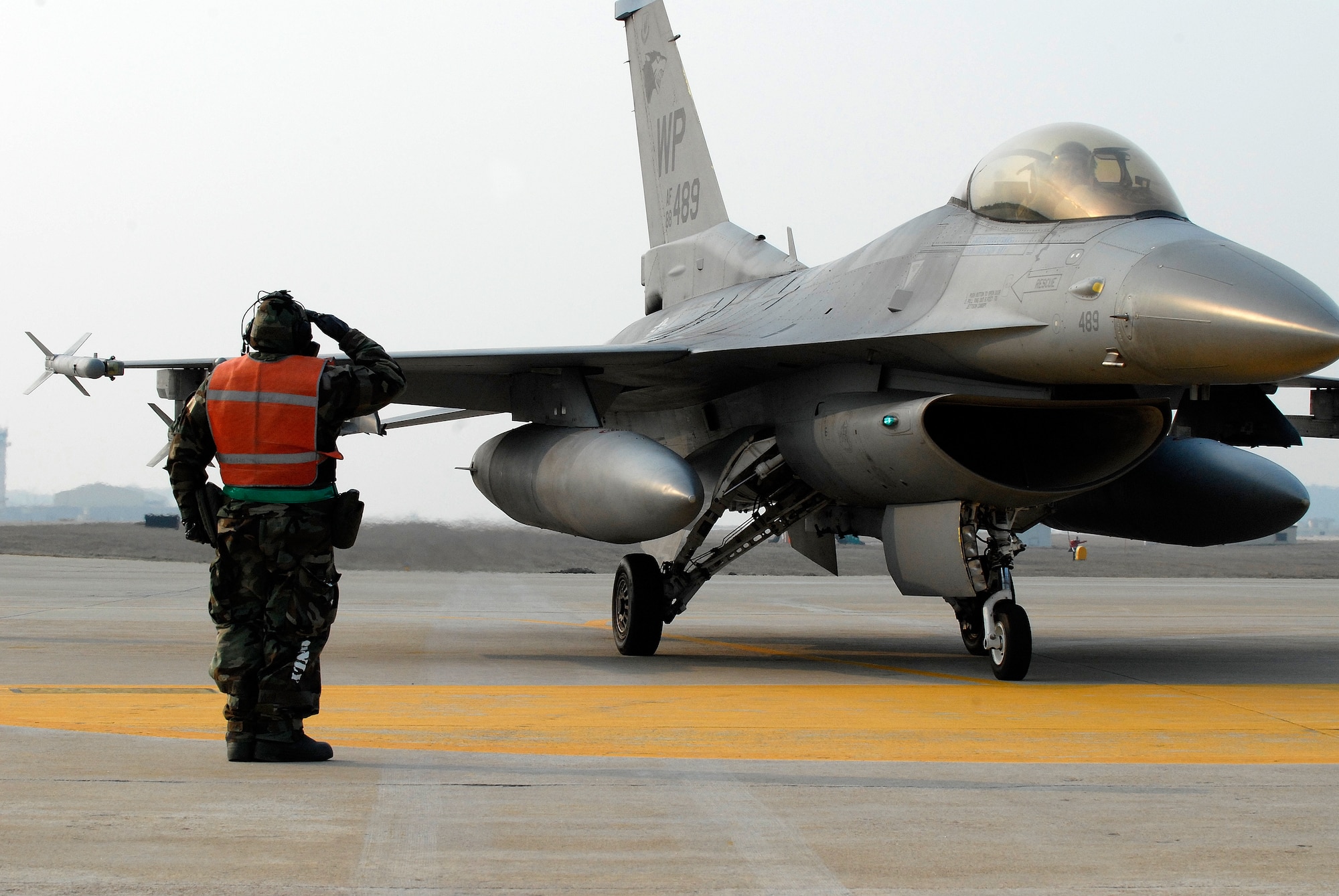 A member of the 8th Aircraft Maintenance Squadron salutes the pilot of an F-16 Fighting Falcon after de-arming the aircraft at Kunsan Air Base, Republic of Korea, April 1, 2009. Kunsan Airmen are currently participating in Peninsula-wide Operational Readiness Exercise Bev erly Bulldog 09-02, in preparation for an Operational Readiness Inspection. (U.S. Air Force Photo by Staff Sgt. Jason Colbert)