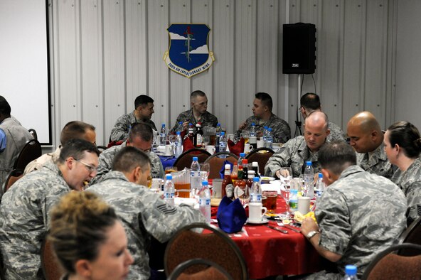 SOUTHWEST ASIA -- Guests enjoy breakfast and fellowship at the 380th Air Expeditionary Wing's annual National Prayer Breakfast. More than 70 Airmen gathered together for the breakfast here April 1. (U.S. Air Force photo by Staff Sgt. Mike Andriacco) (Released)