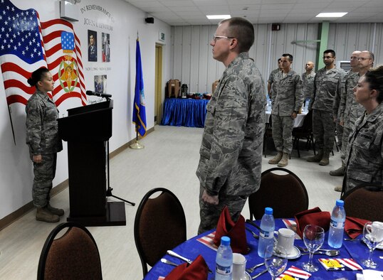 SOUTHWEST ASIA -- 2nd Lt. Sheena Georgulis, 963rd Expeditionary Airborne Air Control Squadron, sings the national anthem at the opening of the 380th Air Expeditionary Wing's annual National Prayer Breakfast. More than 70 Airmen gathered together in fellowship for the breakfast here April 1. (U.S. Air Force photo by Staff Sgt. Mike Andriacco) (Released)