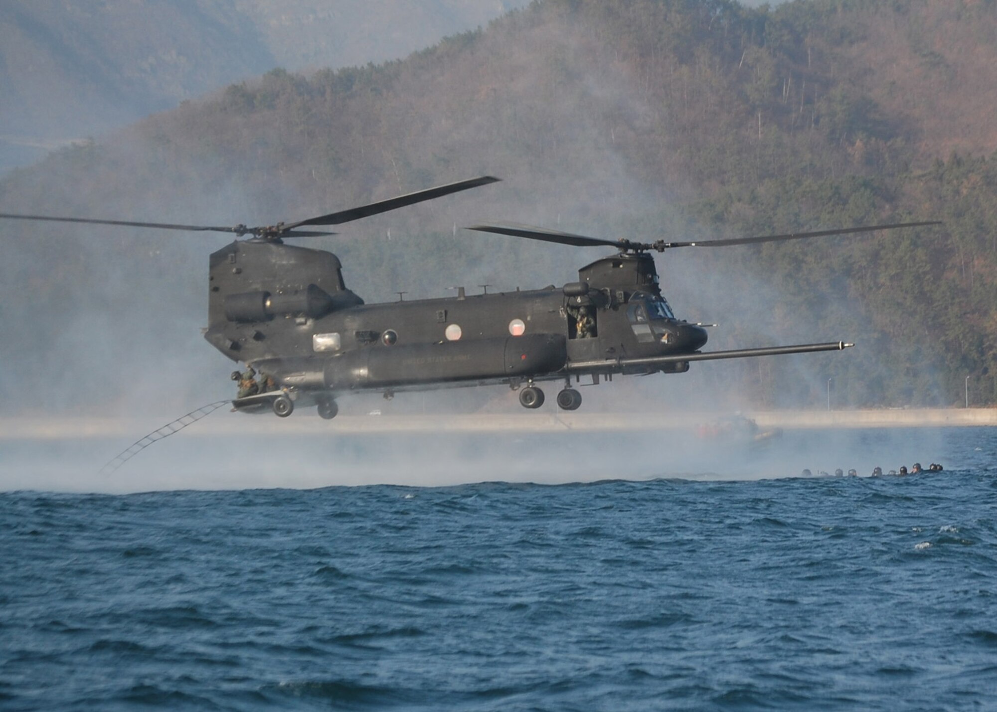 NEAR CHINHAE, Republic of Korea -- Crew members throw a rope ladder out the back of a U.S. Army MH-47 helicopter from the 160th Special Operations Aviation Regiment (Airborne) to retrieve members of the 320th Special Tactics Squadron from the water during an infiltration/exfiltration training mission here March 20 during Foal Eagle 2009.  Foal Eagle is an annual combined training exercise for U.S. and Republic of Korea forces to evaluate and improve their ability to coordinate procedures, plans and systems necessary to defend the ROK. The 320th STS is deployed from Kadena Air Base, Japan, and the 160th SOAR is deployed from Fort Lewis, Wash. (U.S. Air Force photo by James D'Angina)
