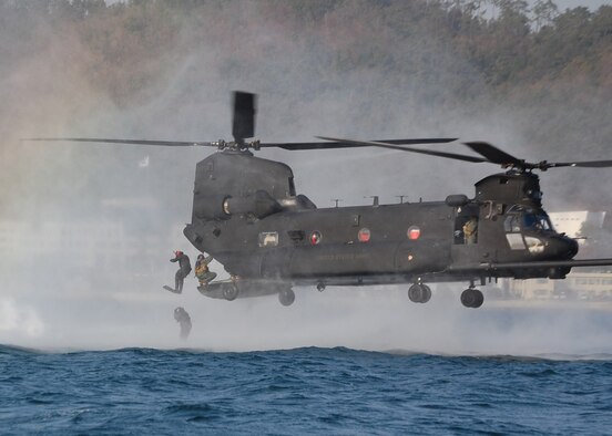 NEAR CHINHAE, Republic of Korea -- Members of the 320th Special Tactics Squadron jump into the water from the back of a U.S. Army MH-47 helicopter from the 160th Special Operations Aviation Regiment (Airborne) during an infiltration/exfiltration training mission here March 20 during Foal Eagle 2009.  Foal Eagle is an annual combined training exercise for U.S. and Republic of Korea forces to evaluate and improve their ability to coordinate procedures, plans and systems necessary to defend the ROK. The 320th STS is deployed from Kadena Air Base, Japan, and the 160th SOAR is deployed from Fort Lewis, Wash. (U.S. Air Force photo by James D'Angina)