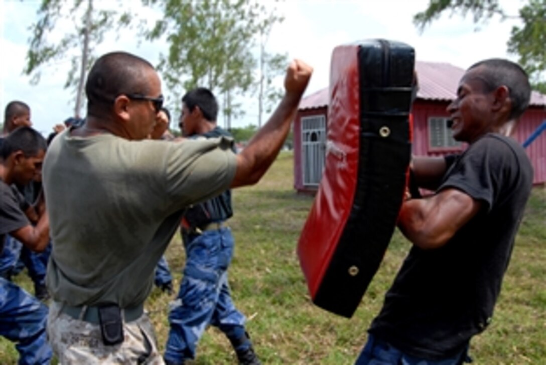 U.S. Marine Corps Cpl. Robert Ortega shows a Nicaraguan Marine proper punching technique during a Marine Corps Martial Arts Program class in the Bluefileds, Nicaragua, March, 30, 2009. Ortega is an instructor assigned to the Marine Corps Training and Advisory Group.