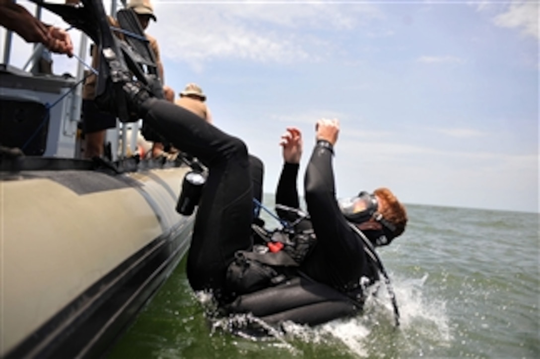 U.S. Navy Petty Officer 2nd Class John Handrahan from Explosive Ordnance Disposal Mobile Unit 8 dives into Lake Victoria during a search and recovery operation in Entebbe, Uganda, on March 28, 2009.  The unit is working with Combined Joint Task Force-Horn of Africa and the government of Uganda to conduct search and recovery operations of human remains and flight data recorders from the wreckage of an Ilyushin 76 passenger aircraft that crashed in Lake Victoria on March 9, 2009.  