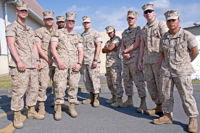From left to right, Cpl. Bryan Morgan, Lance Cpl. Justin McDougall, Cpl. Neilon Baptiste, Cpl. Brian Reda, Sgt. Eric Duran, Cpl. Tara Highbaugh, Cpl. John Hildebrant, Lance Cpl. Kevin Bett and Cpl. Sergio Lopez of Combat Logistics Company 36 strike a triumphant pose here April 1 after the breakfast welcoming them home from their nearly year-long tour in Iraq. During their tour, most of the Marines got their first, long field environment experience and were able to bask in the joy of working long hours, adjusting to the climate, going long spans of time without bathing and disposing of their own bodily waste.