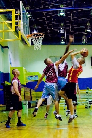 Marine All Weather Attack Squadron 224 players defend their side of the court as an IYAOYAS player aims to score a point during a game April 1 for the Spring Intramural Basketball season at the IronWorks Gym. The score during half time was 21-17 with the IYAOYAS in the lead.