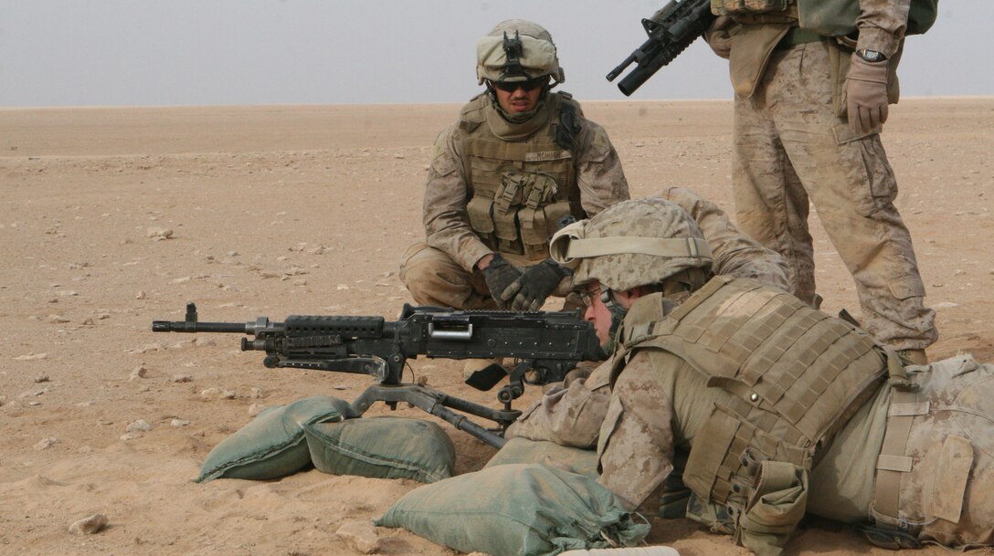 Private First Class Chad McHugh looks on as Marines of the Quick Reaction force engage targets during a weapons training exercise, April 2, 2009.  Although the QRF Marines are originally tankers, they say conducted missions a a QRF helps to mae them more well-rounded Marines.  (U.S. Marine Corps photo by Cpl Alan Addison)