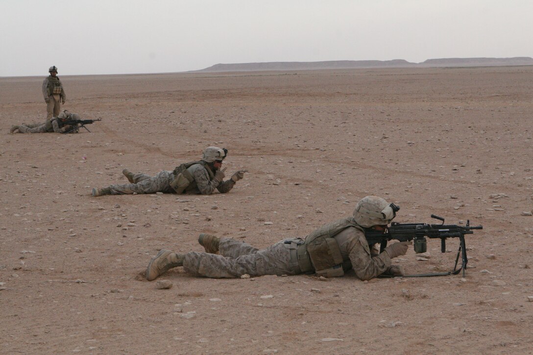 Cpl Carlos Gonzalez, a vehicle commander with Regimental Combat Team 8's Mobile Security Detachment, watches as Marines of the Quick Reaction Force practice joint target engement during  weapons training exercise, April 2, 2009.::r::::n::RCT-8 Marines instructed the QRF in a variety of infanty weapons tactics.