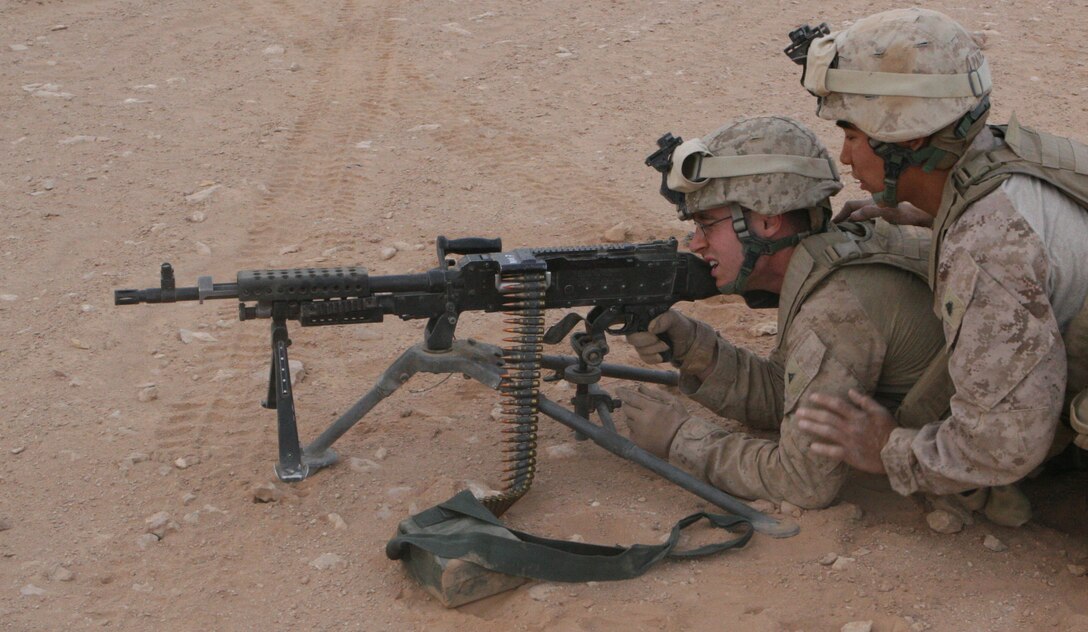 A machinegun team from the Quick Reaction Force, based at Al Asad Airbase, practice target engagement during a weapons training exercise April 2, 2009.  The QRF Marines fired the M240 Bravo machiegun and the M249 squad automatic weapon during the training exercise.