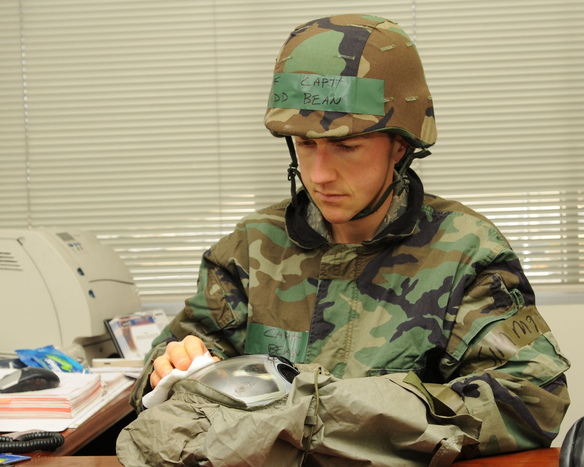 YOKOTA AIR BASE, Japan -- Captain Judd Bean, 374th Airlift Wing assistant staff judge advocate, cleans his gas mask April 3 during Phase II of Exercise Beverly Morning 09-03. Yokota is conducting an exercise March 30 through April 3 to maintain operational readiness. (U.S. Air Force photo/ Airman Sean Martin)