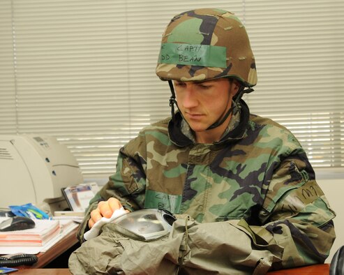 Captain Judd Bean, 374th Airlift Wing assistant staff judge advocate, cleans his gas mask April 3 at Yokota Air Base, Jpan. Base personnel are conducting Phase II of Exercise Beverly Morning 09-03 to maintain operational readiness. (U.S. Air Force photo/Airman Sean Martin)