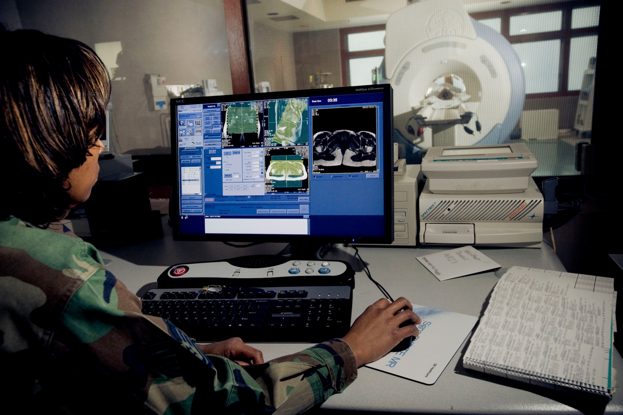 ELMENDORF AIR FORCE BASE, Alaska -- Tech. Sgt. Annette Ferguson-Sims watches over a patient while the newly upgraded magnetic resonance imaging, more commonly known as MRI, scans the subject April 1, 2009. Ferguson-Sims, 3rd Medical Operations Squadron, uses the upgraded MRI to view much more detail in the photographs than before. (U.S. Air Force photo by Master Sgt. Keith Brown)