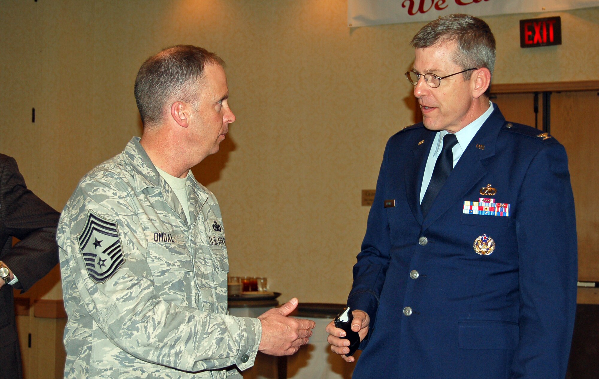 Chief Master Sgt. Tim Omdal, 21st Space Wing command chief,   converses with Col. Robert Freddell, Air Force Academy chief scientist, at a gathering of business and local military leaders at the Antlers Double Tree Hotel March 19. The academy and Peterson AFB are participating in the Regional Utilities Working Group, a collaboration to meet large scale energy projects helping stakeholders meet regional development goals. 