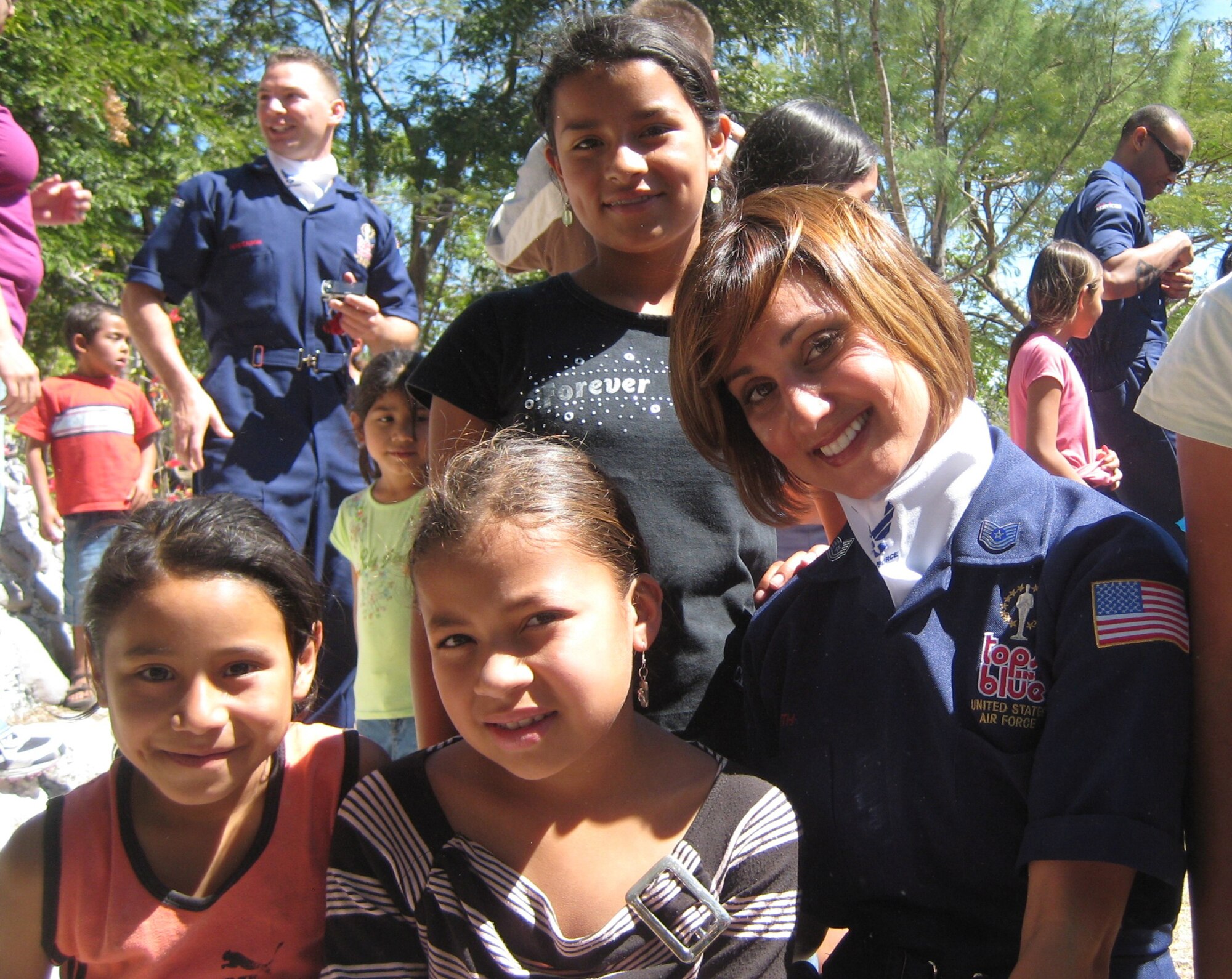 Tech. Sgt. Chandra Smith visits with children in Honduras during Tops in Blue’s January performance at Soto Cano Air Base. The team’s visit to three Honduran orphanages was the highlight of Smith’s personal experience with the Air Force’s expeditionary entertainment group. (Courtesy photo)