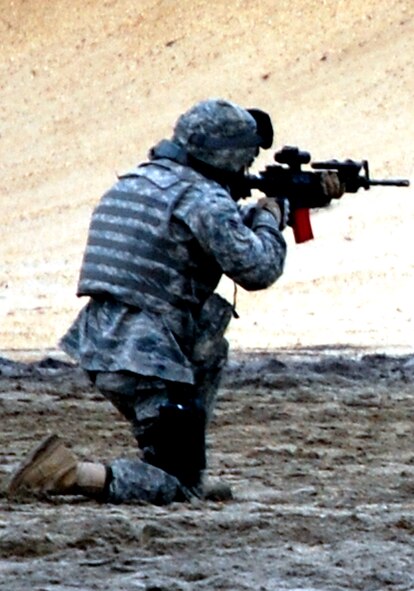 A security forces Airman training for an upcoming deployment participates in live-fire tactical shooting on a Fort Dix, N.J., range on March 26, 2009.  The training was provided by the U.S. Air Force Expeditionary Center's 421st Combat Training Squadron.  (U.S. Air Force Photo/Tech. Sgt. Scott T. Sturkol)