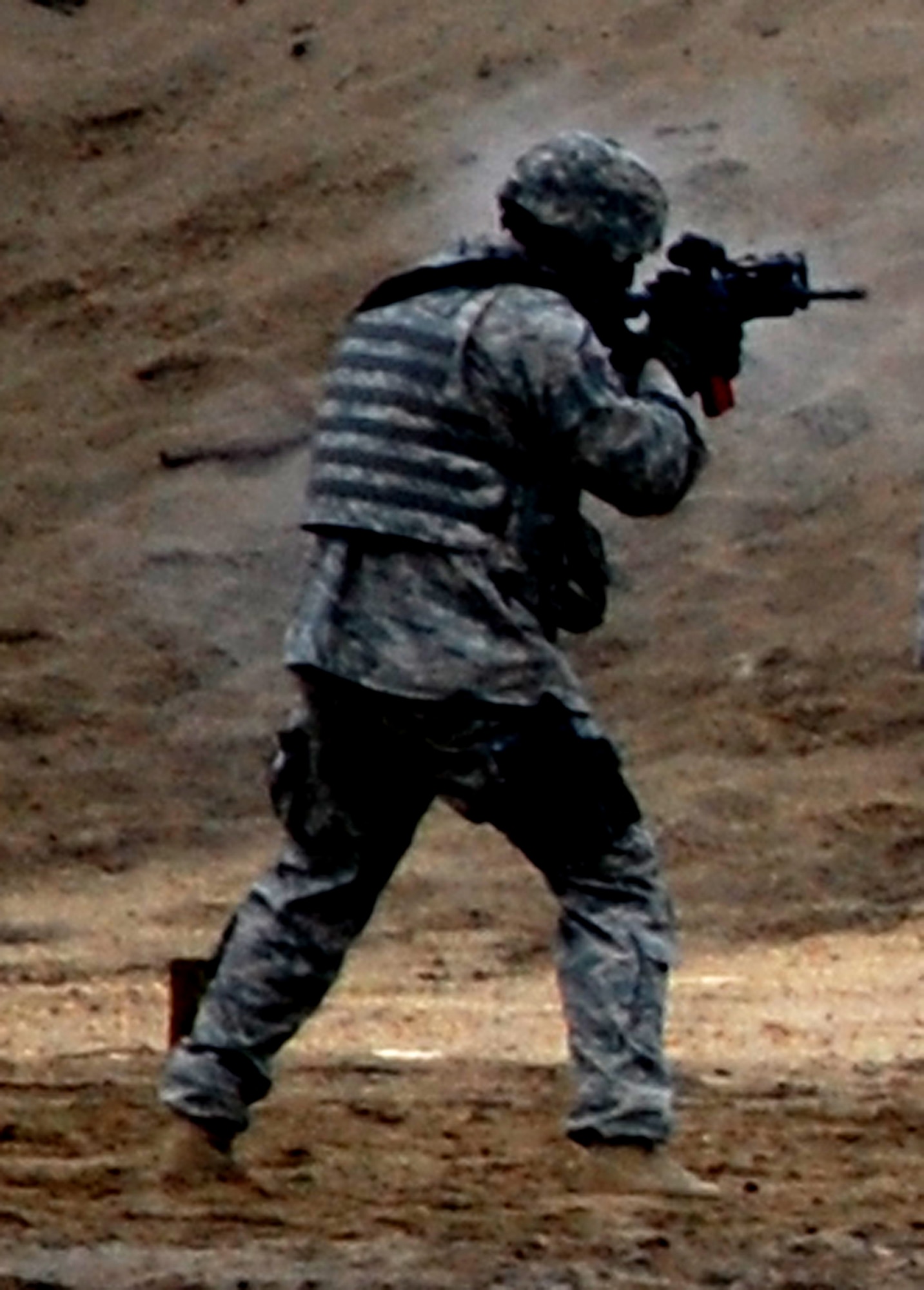 A security forces Airman training for an upcoming deployment participates in live-fire tactical shooting on a Fort Dix, N.J., range on March 26, 2009.  The training was provided by the U.S. Air Force Expeditionary Center's 421st Combat Training Squadron.  (U.S. Air Force Photo/Tech. Sgt. Scott T. Sturkol)